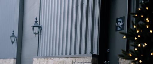 man in black shirt standing beside counter