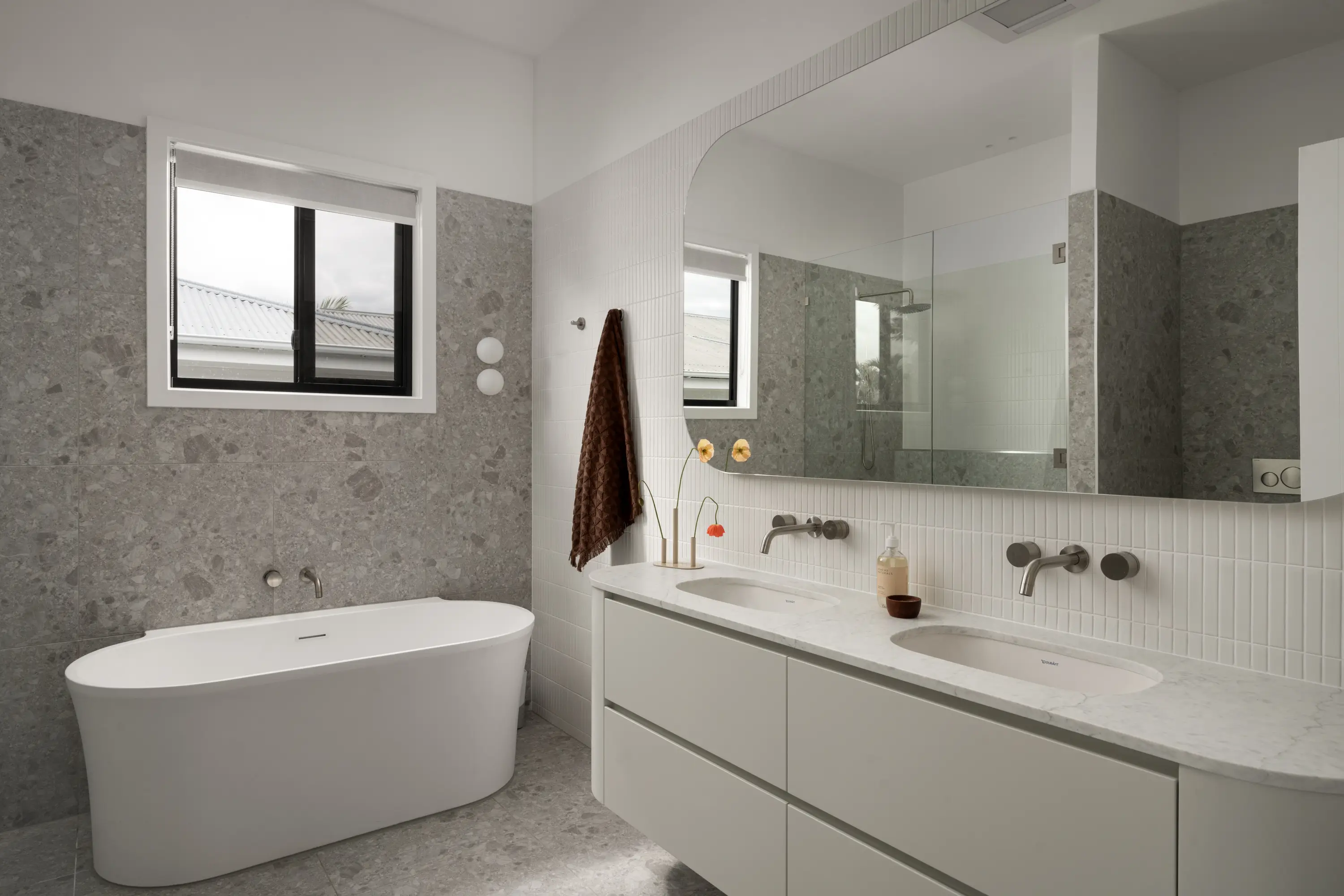 Luxury bathroom retreat with double basins and bath under the window