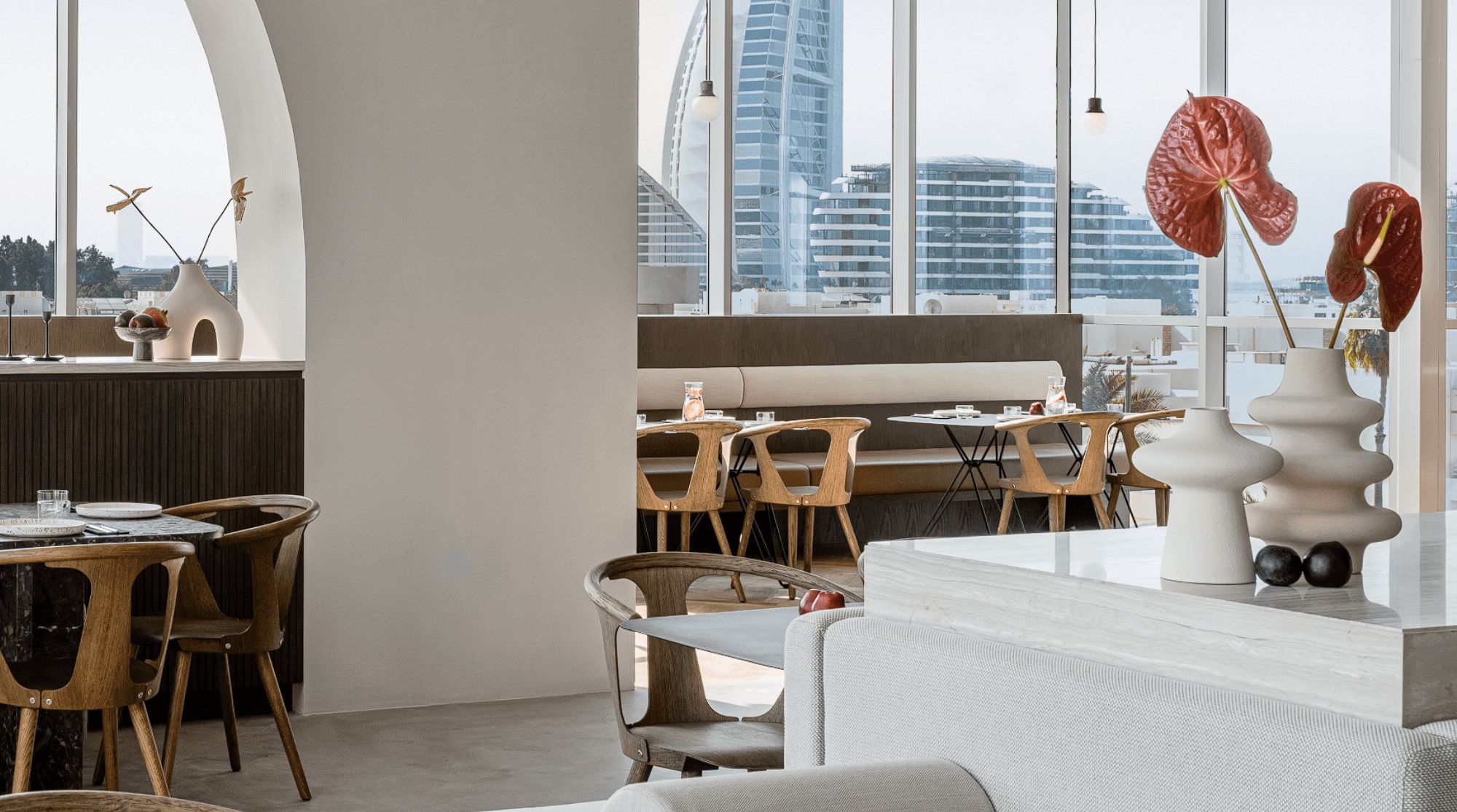 21grams in Dubai with a brown and white interior with wooden seating, modern tables, and minimalist decorations.