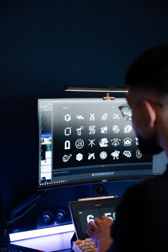 Designer reviewing a collection of logo marks on screen at Hival Design studio