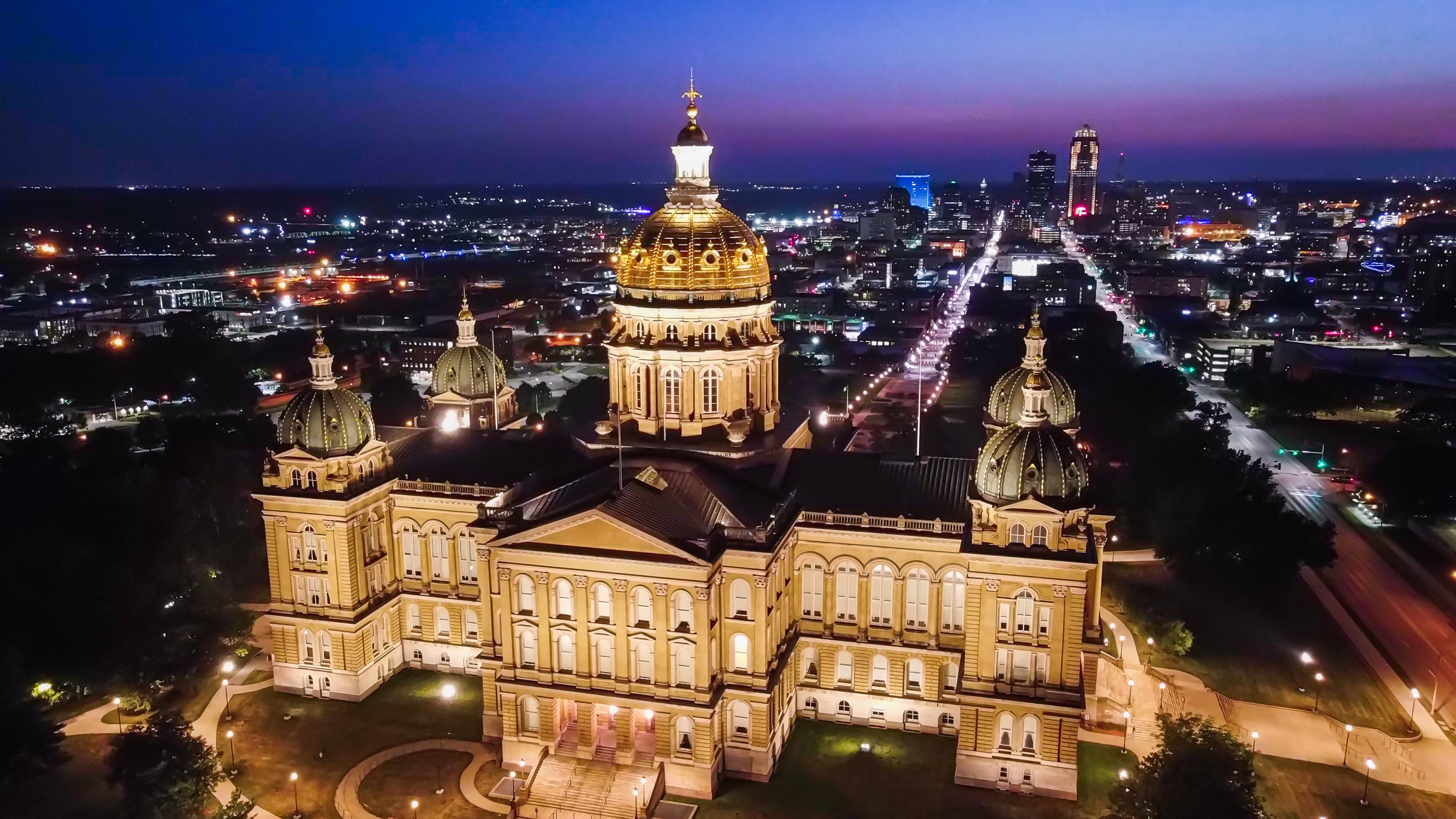 Drone view of Des Moines Capitol Building lit up at night, Iowa, USA