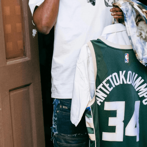 man in green 5 American football jersey holding ball