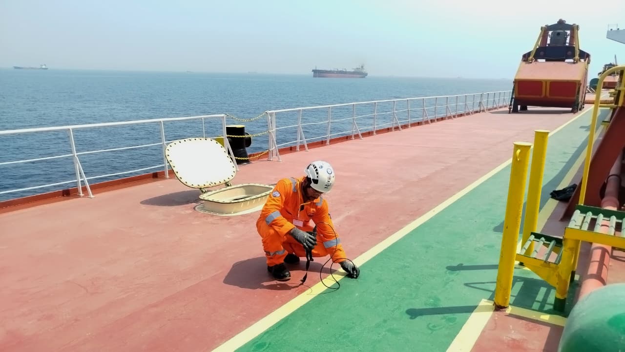 Riding squad UTG inspection of deck and cross deck plating at Khalid Port, UAE, for marine cargo hold thickness assessment.