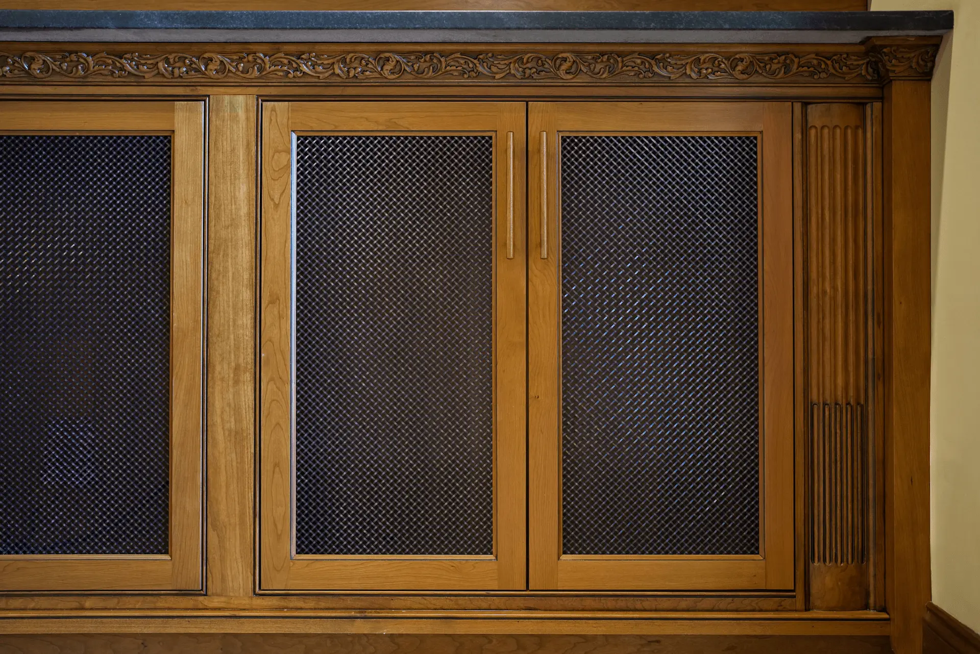 Close-up of the intricate finish work on the entertainment room's custom cabinetry, exemplifying superior craftsmanship in the San Juan Capistrano remodel. Photo by Todd Huge.