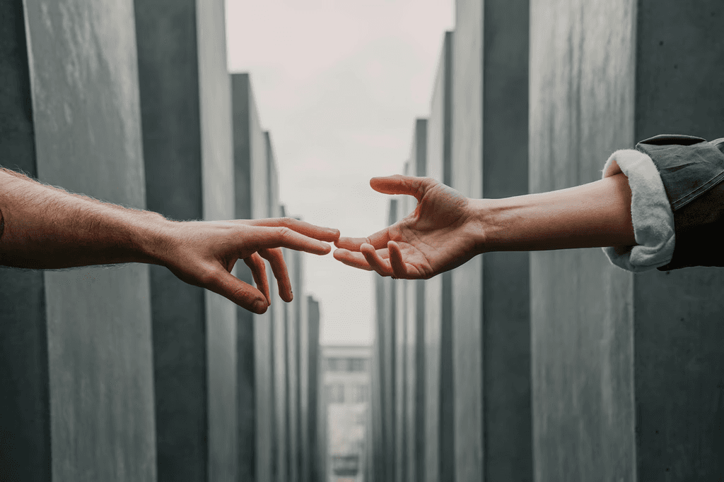 Two people reaching toward each other, representing supportive and collaborative therapeutic relationships