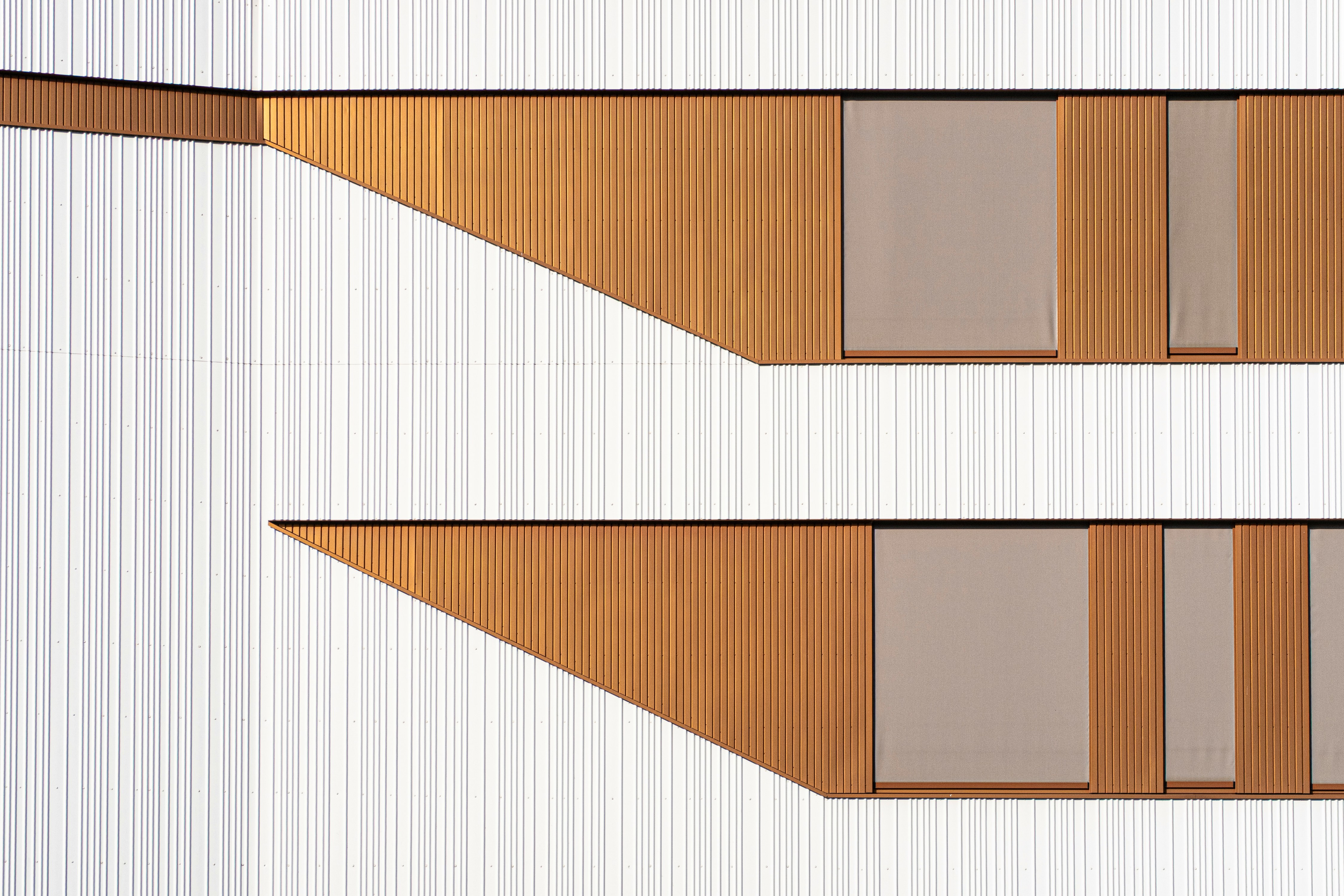 Geometric architectural details with copper and grey panels.