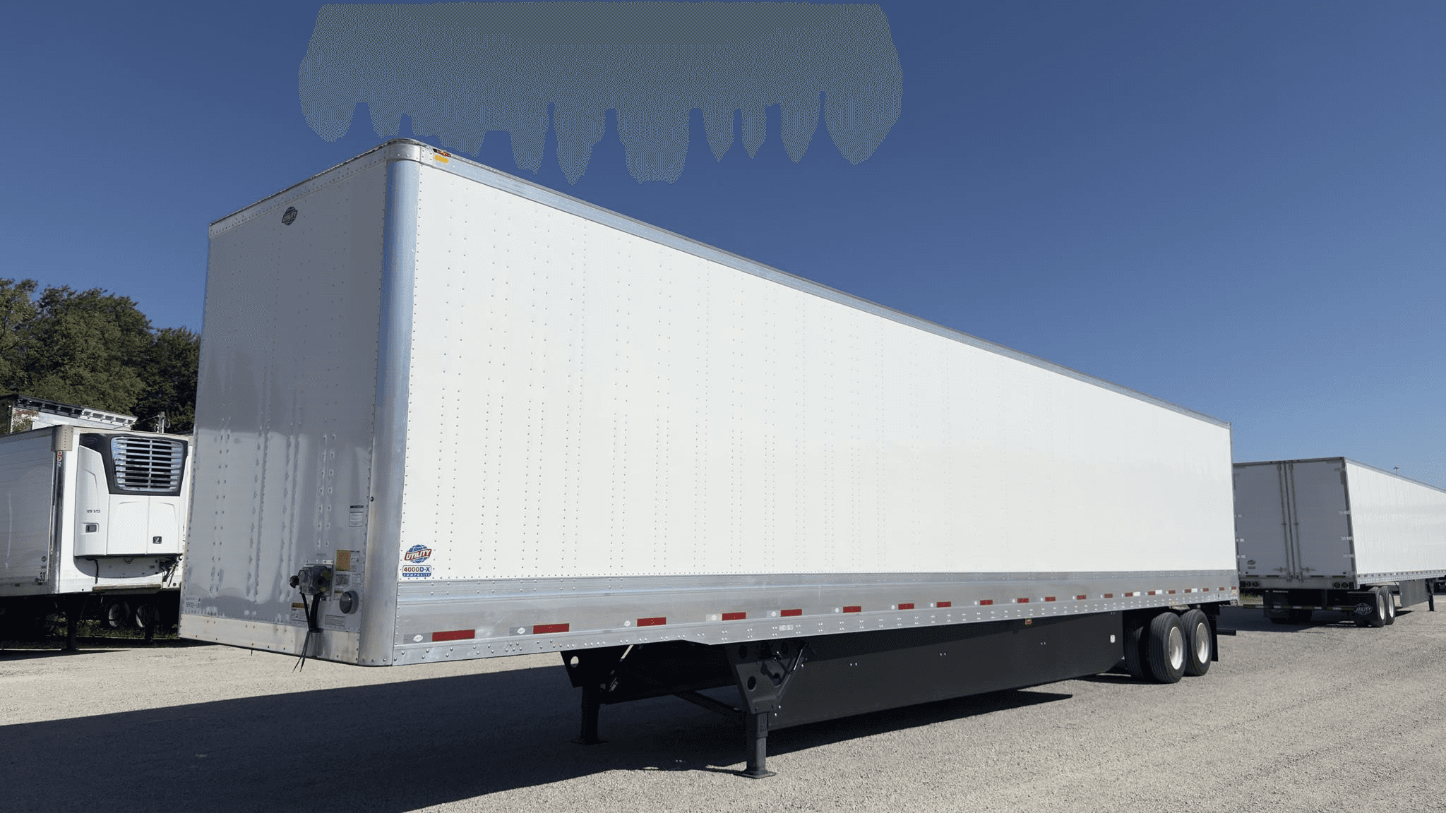 White 53-foot dry van semi-trailer parked in a commercial trailer yard