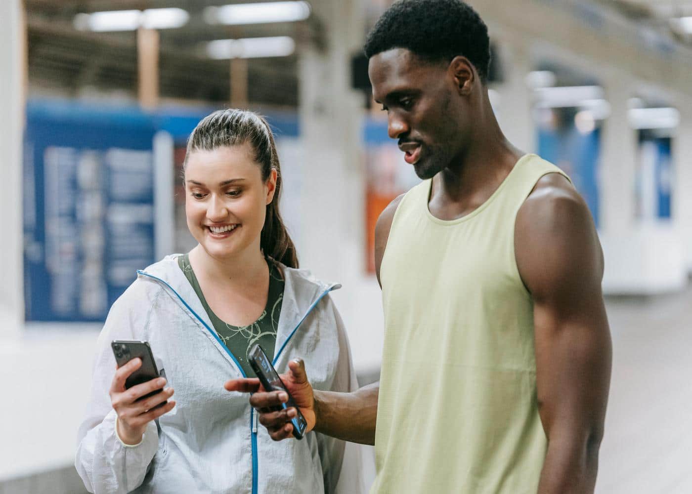 Man and woman in workout clothes looking at smart phone
