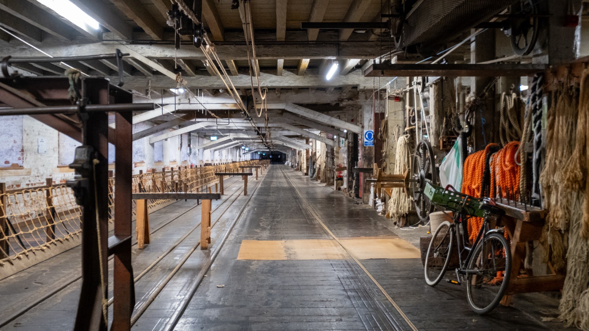 Two classic volkswagen beetles, one green, one cream.