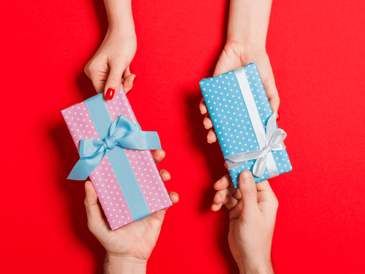 two pairs of hands holding gifts for each other