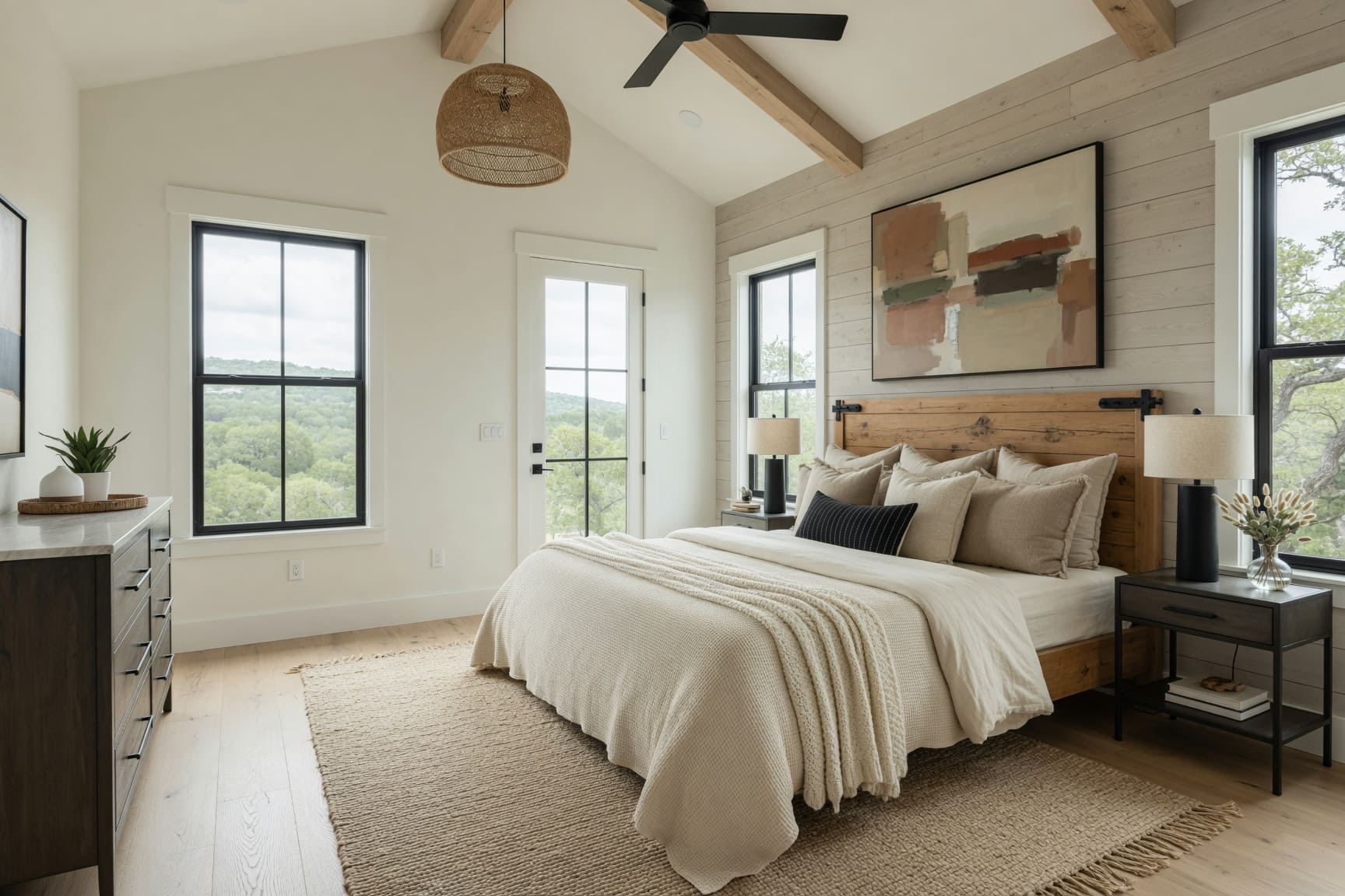 Primary bedroom with vaulted ceiling and garden views