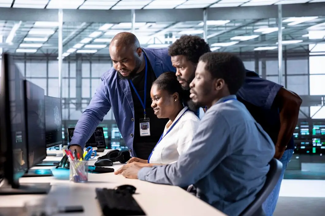  Black woman points to screen at meeting