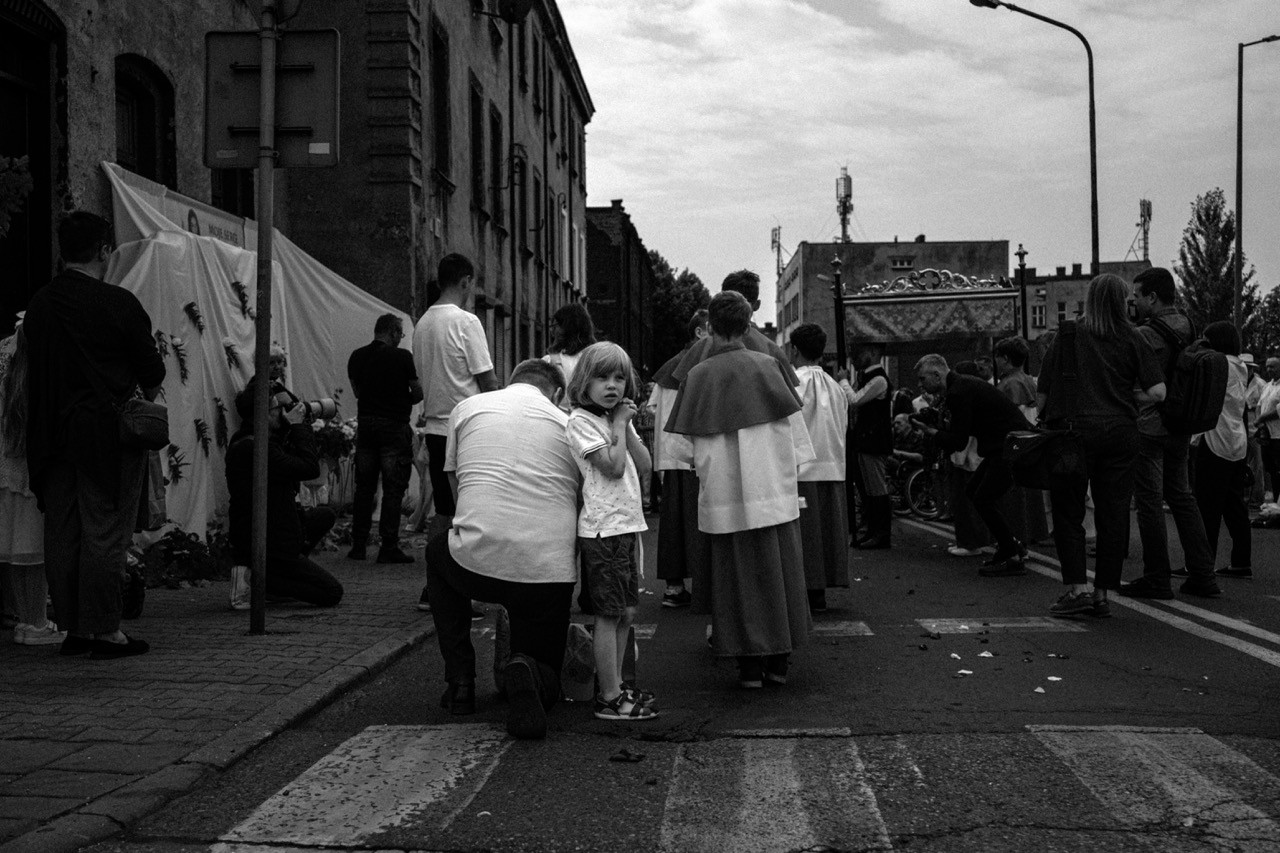 Catholic Corpus Christi procession walking through the streets of Lipiny, documentary photo.