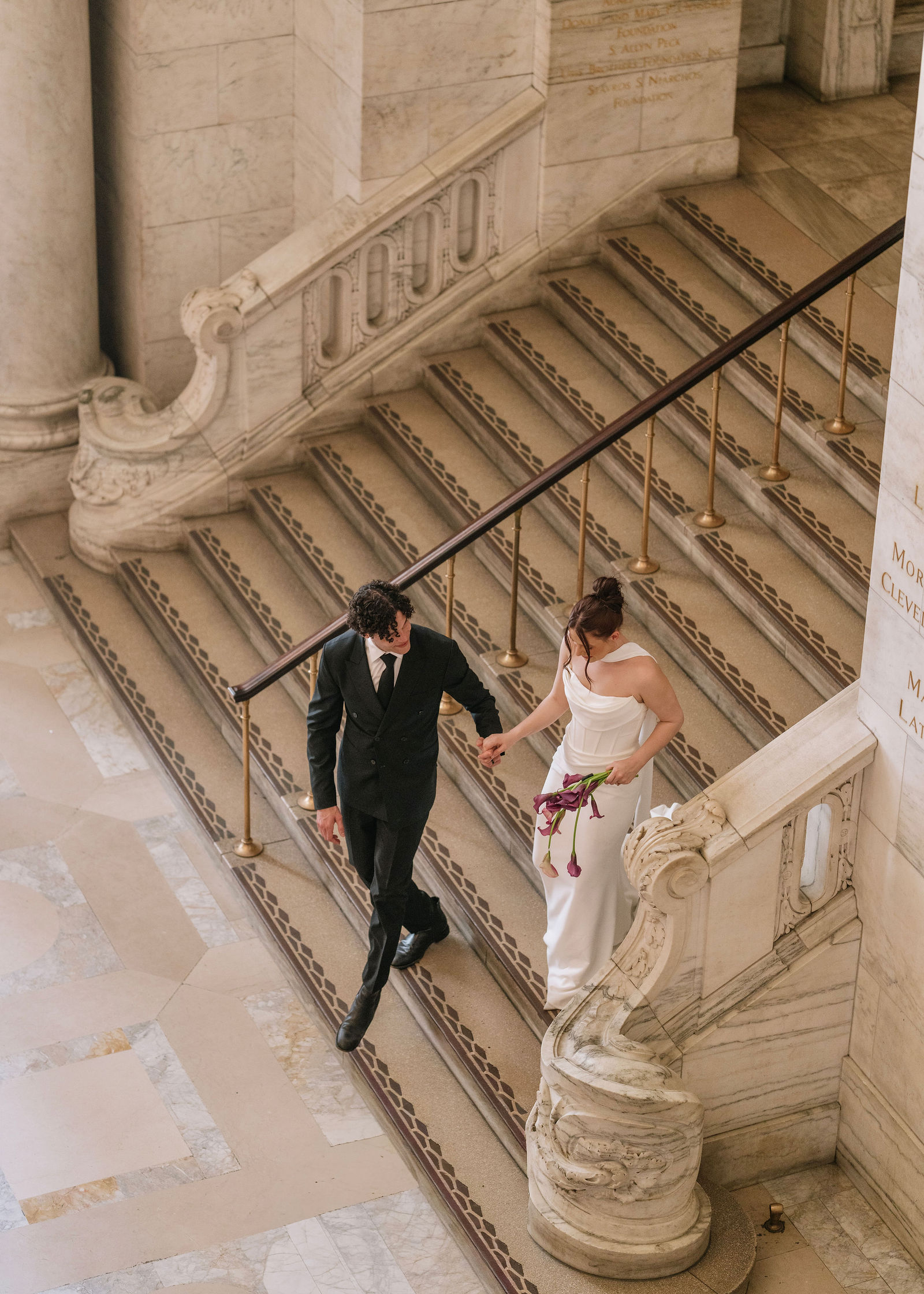 A couple in formal wedding attire embraces intimately in a vast.