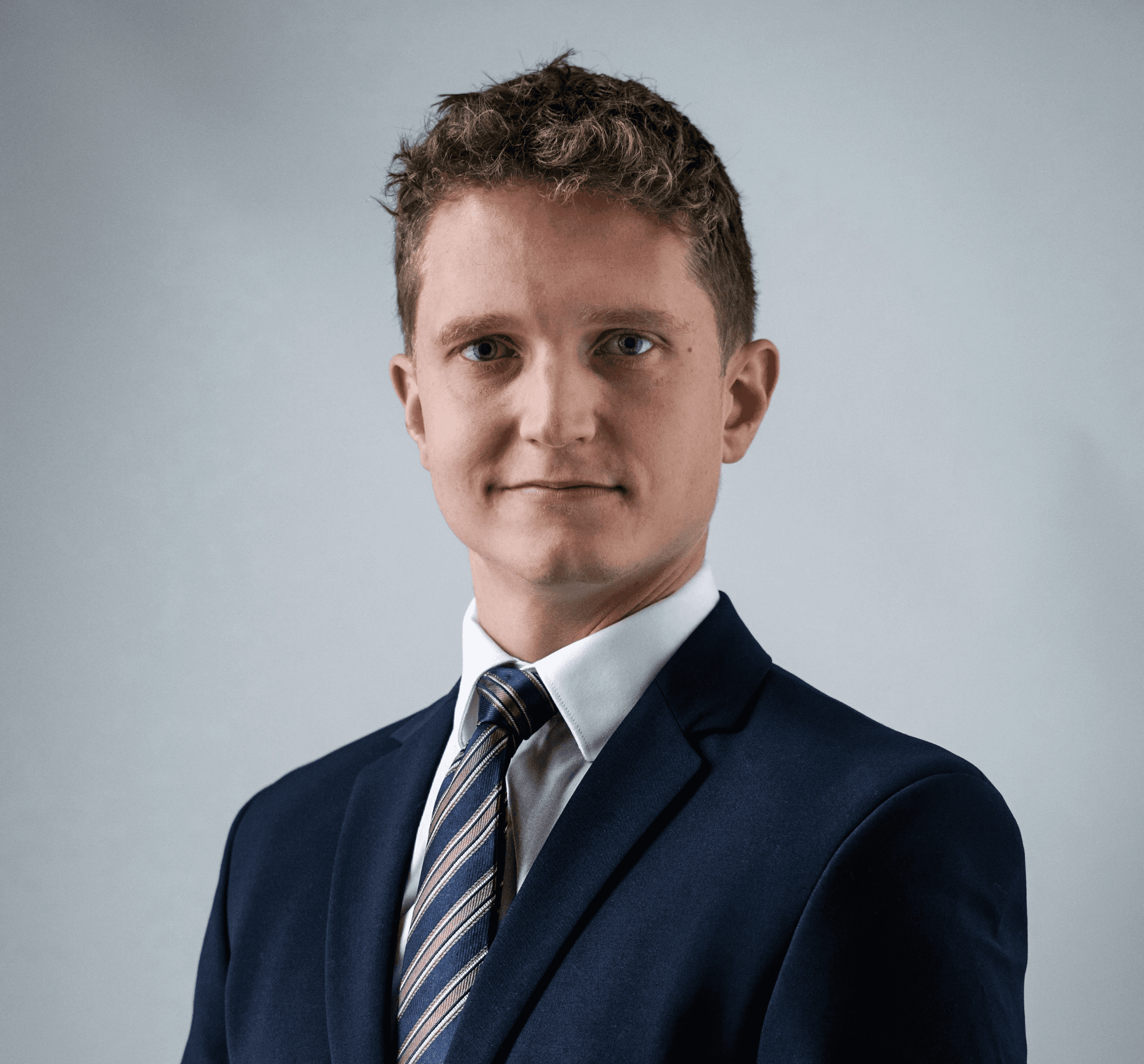 a man in a suit and tie posing for a picture
