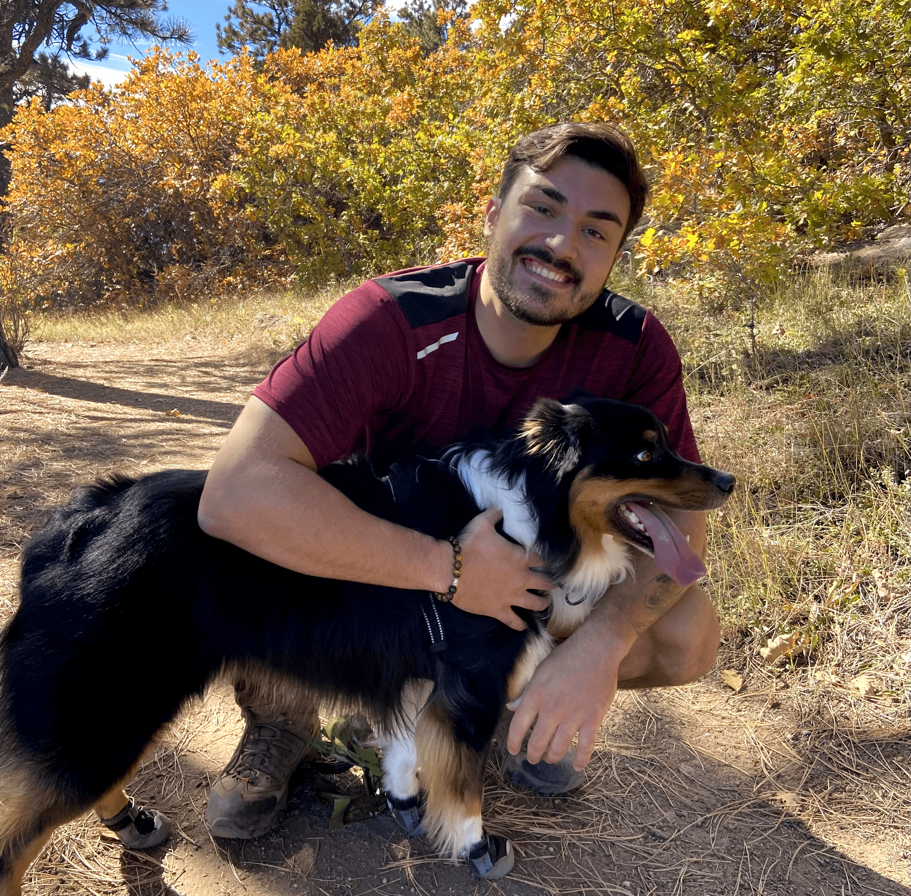 A Photo Of Cameron Hiking With His Australian Shepherd Bowie