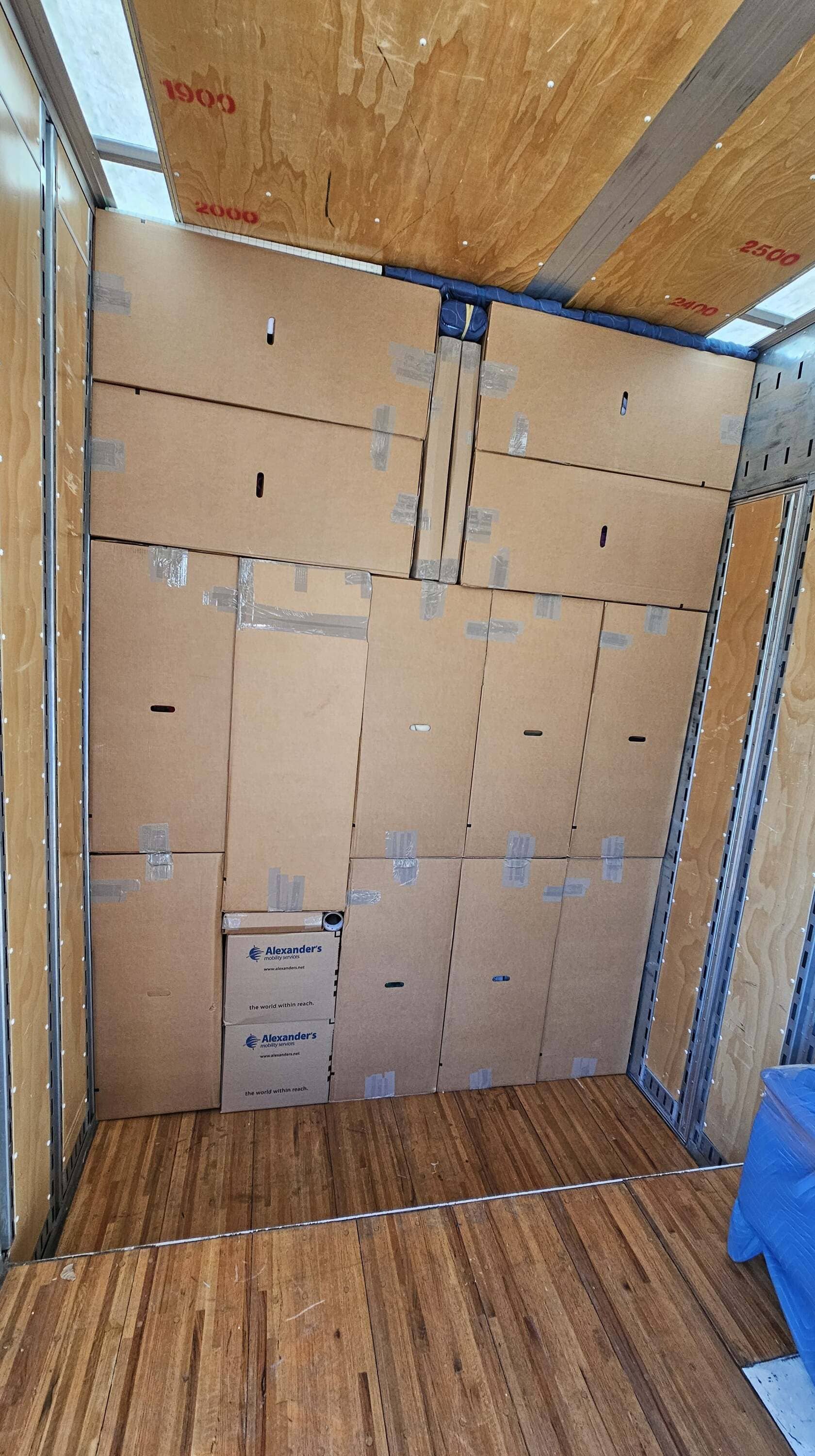 moving boxes inside moving truck after loading moving job