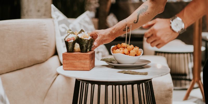 A Malaysian F&B staff serving food