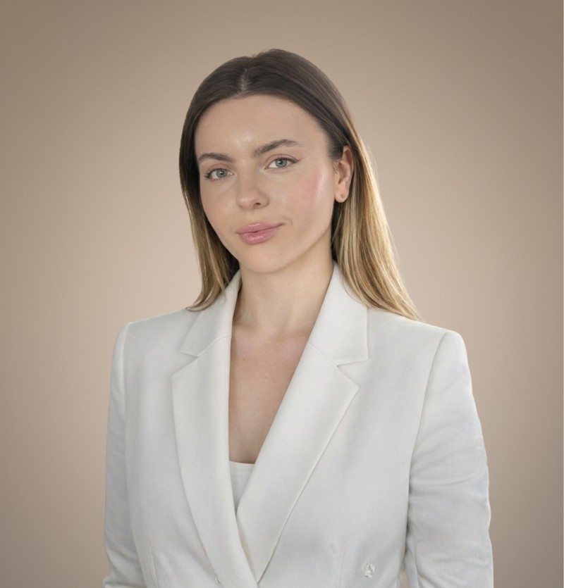 woman in brown coat using macbook air