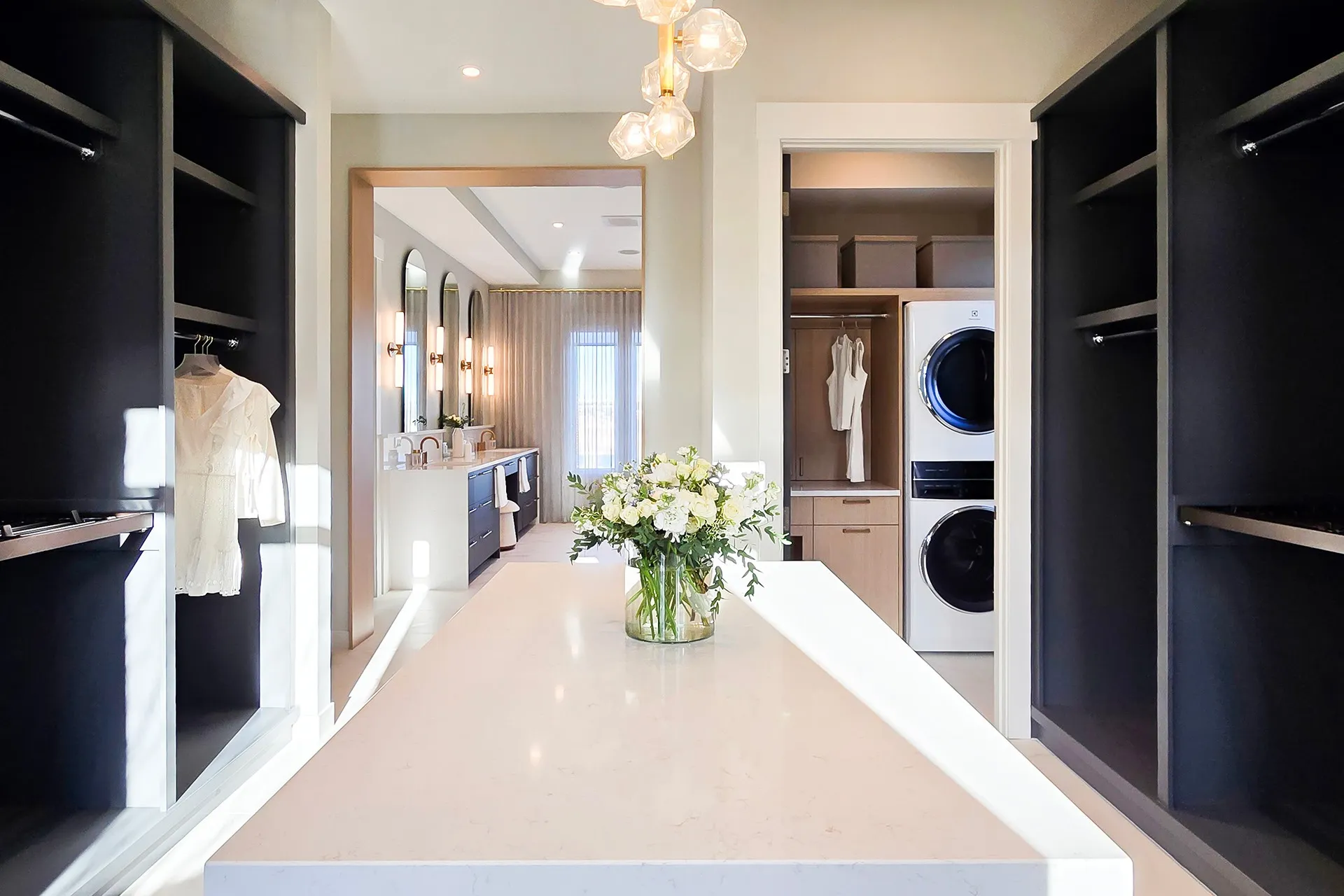 Image of in-suite laundry closet and view to luxurious ensuite bathroom.