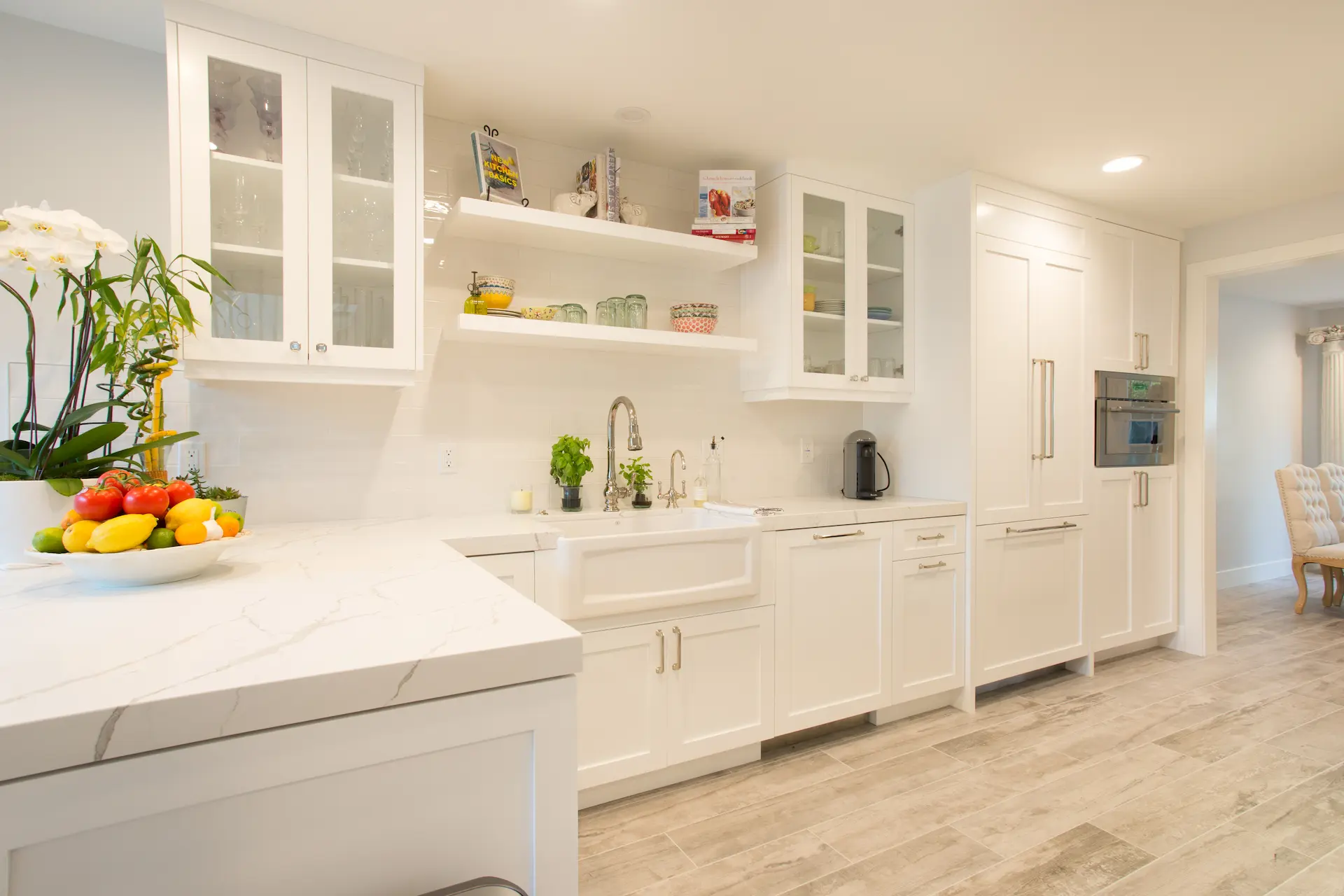 Bright kitchen, white cabinets, apron sink, quartz countertop, from Dana Point Cape Cod remodel, photo by Chris Darnall.