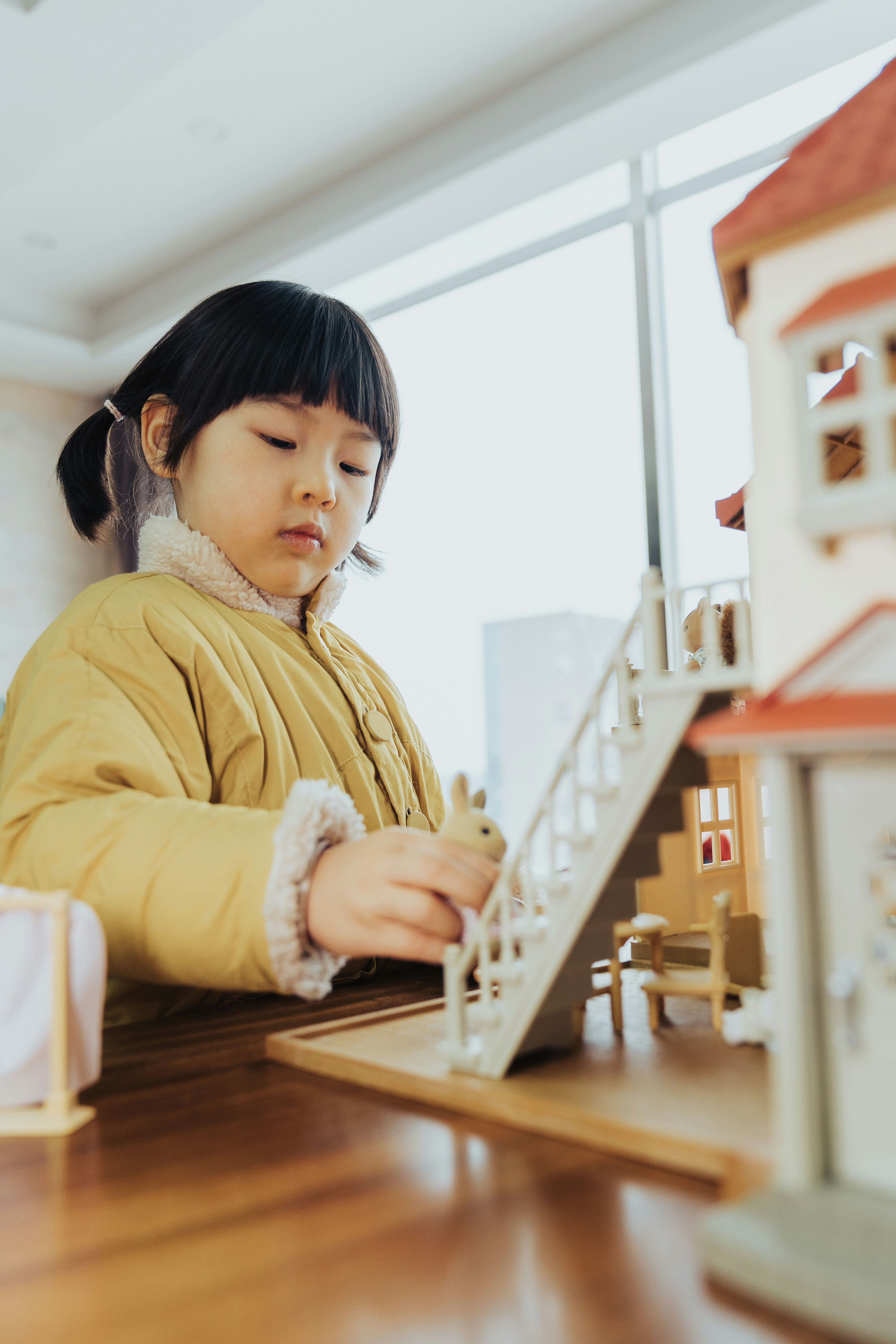 Child playing with dollhouse