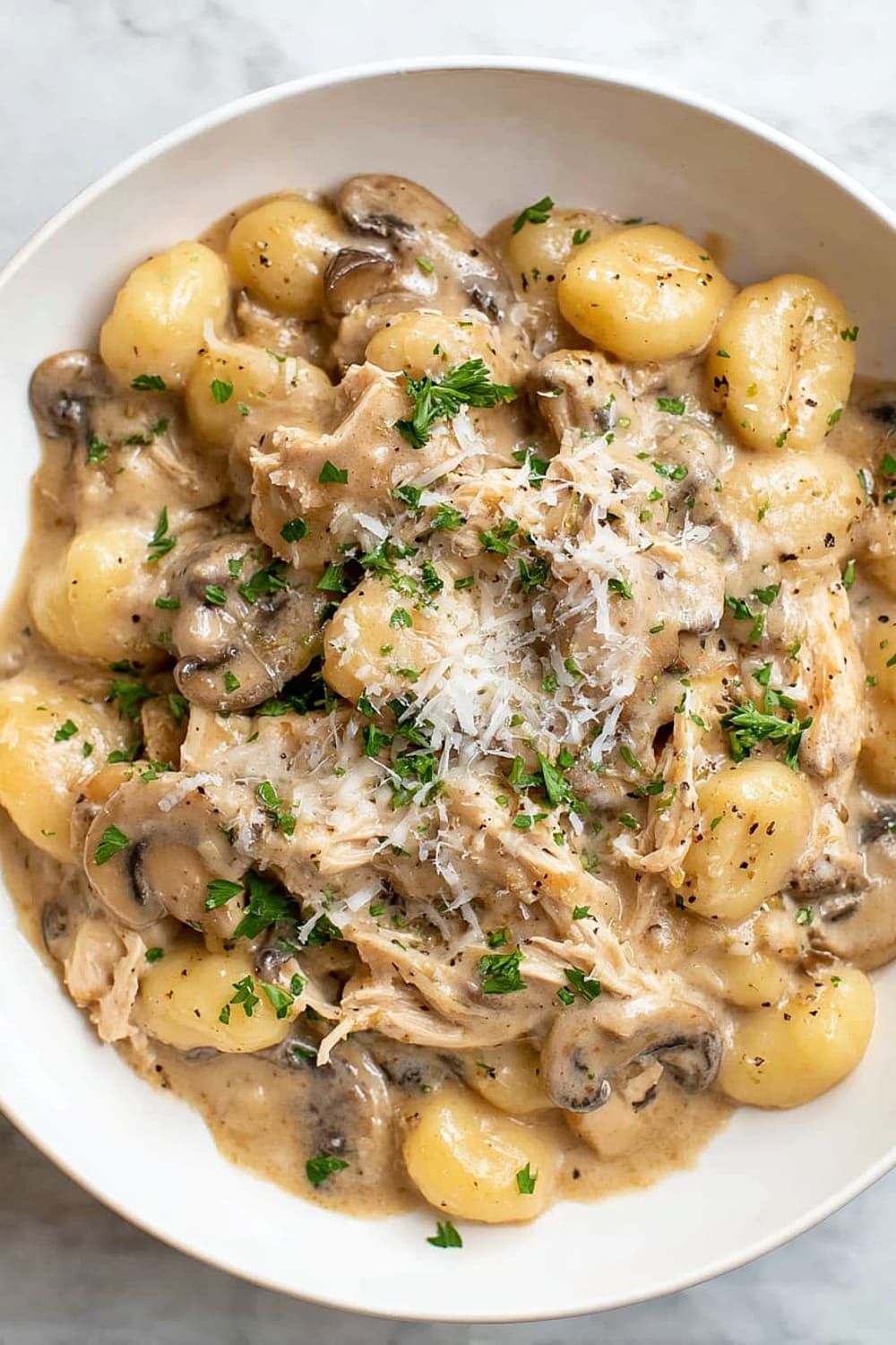 Mushroom Chicken Gnocchi from Pasta 9 Toronto in creamy Alfredo with seasoned ground chicken and fresh spinach.