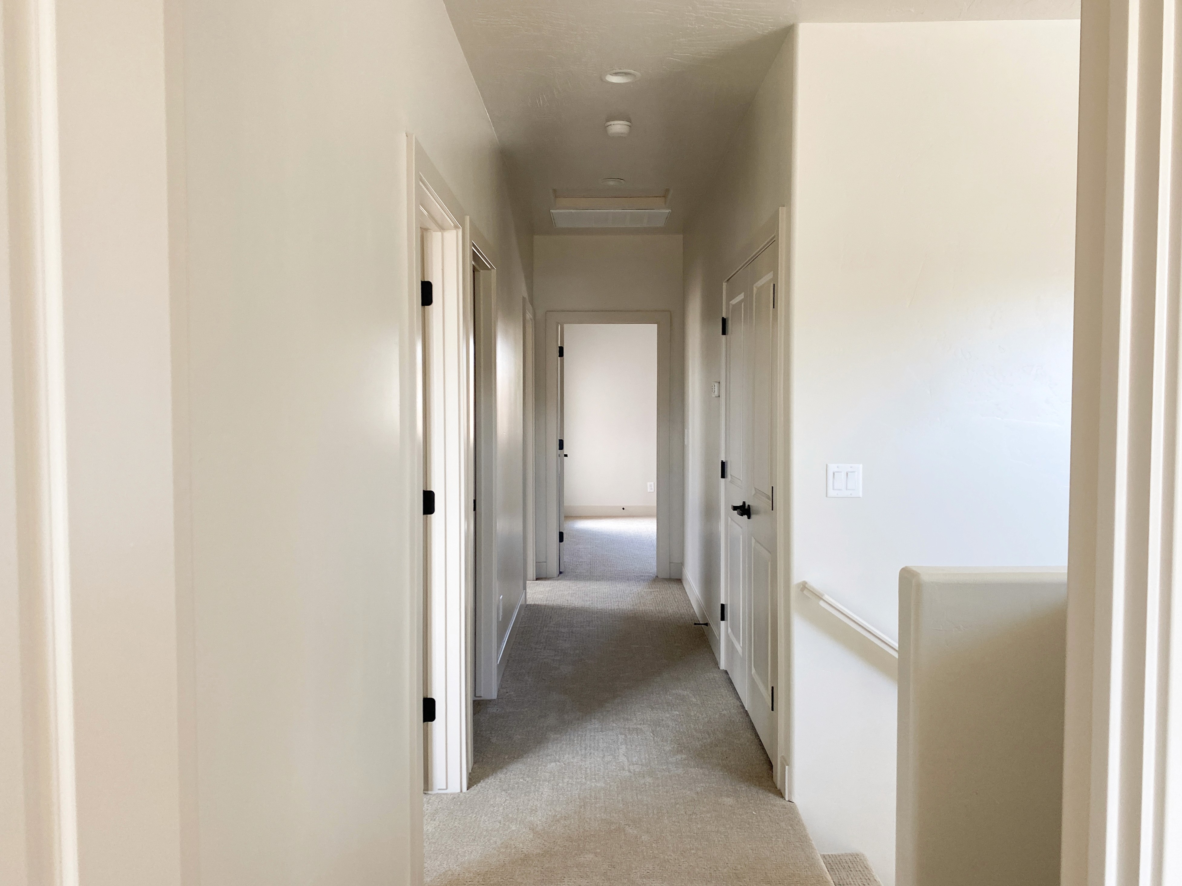 Hallway in a Hurricane, Utah duplex with clean design and natural flow between rooms.