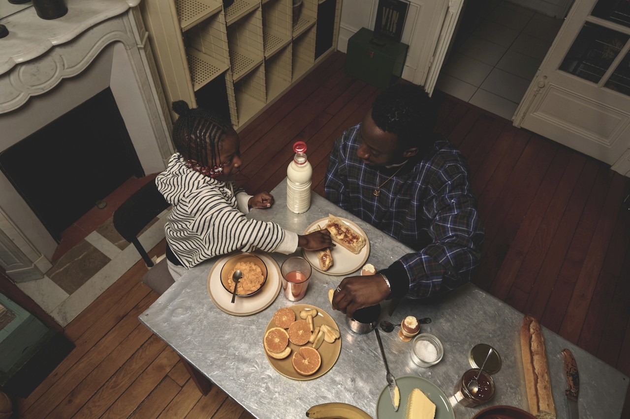 kids lying on a glass land and smiling