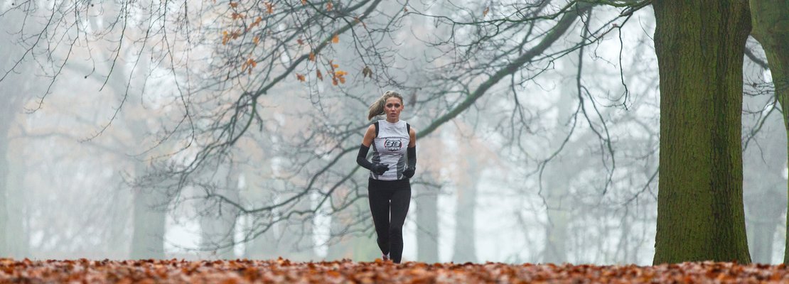 a woman running in foggy woods