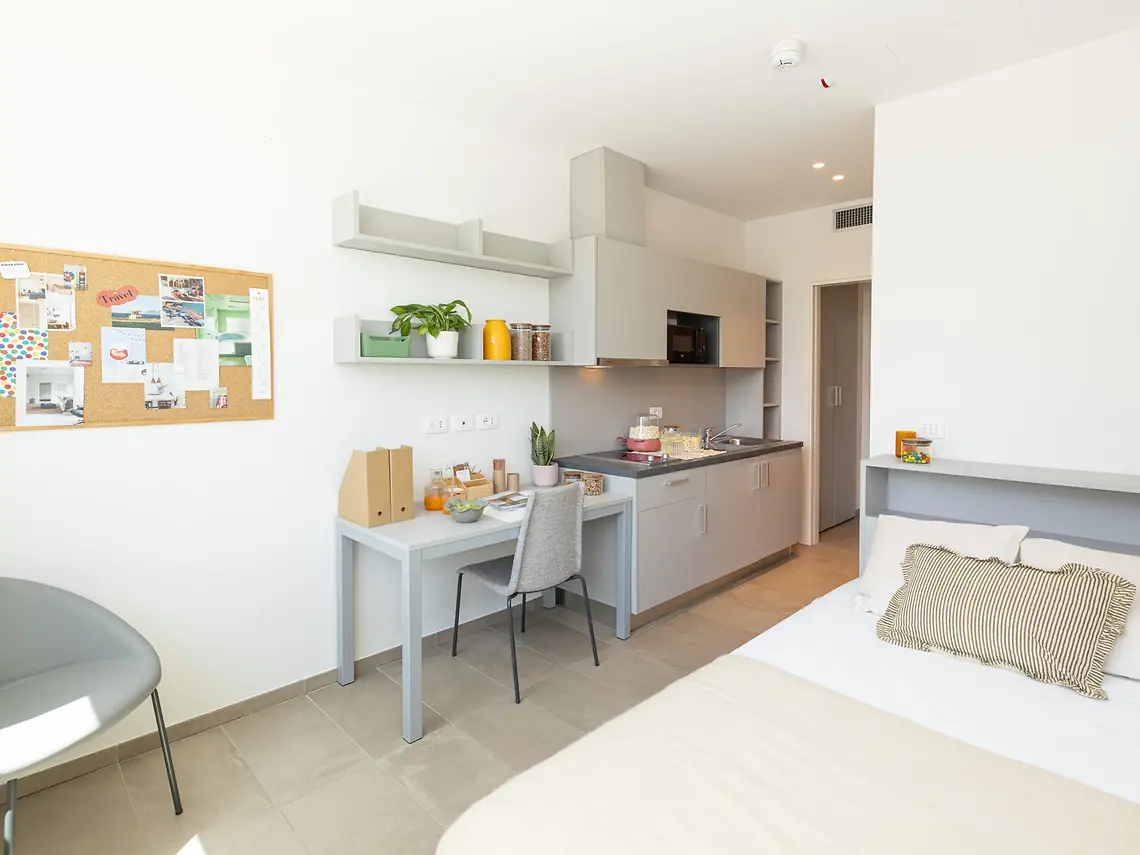 Classic student studio with kitchenette, study desk and pinboard at Florentia Living, Florence
