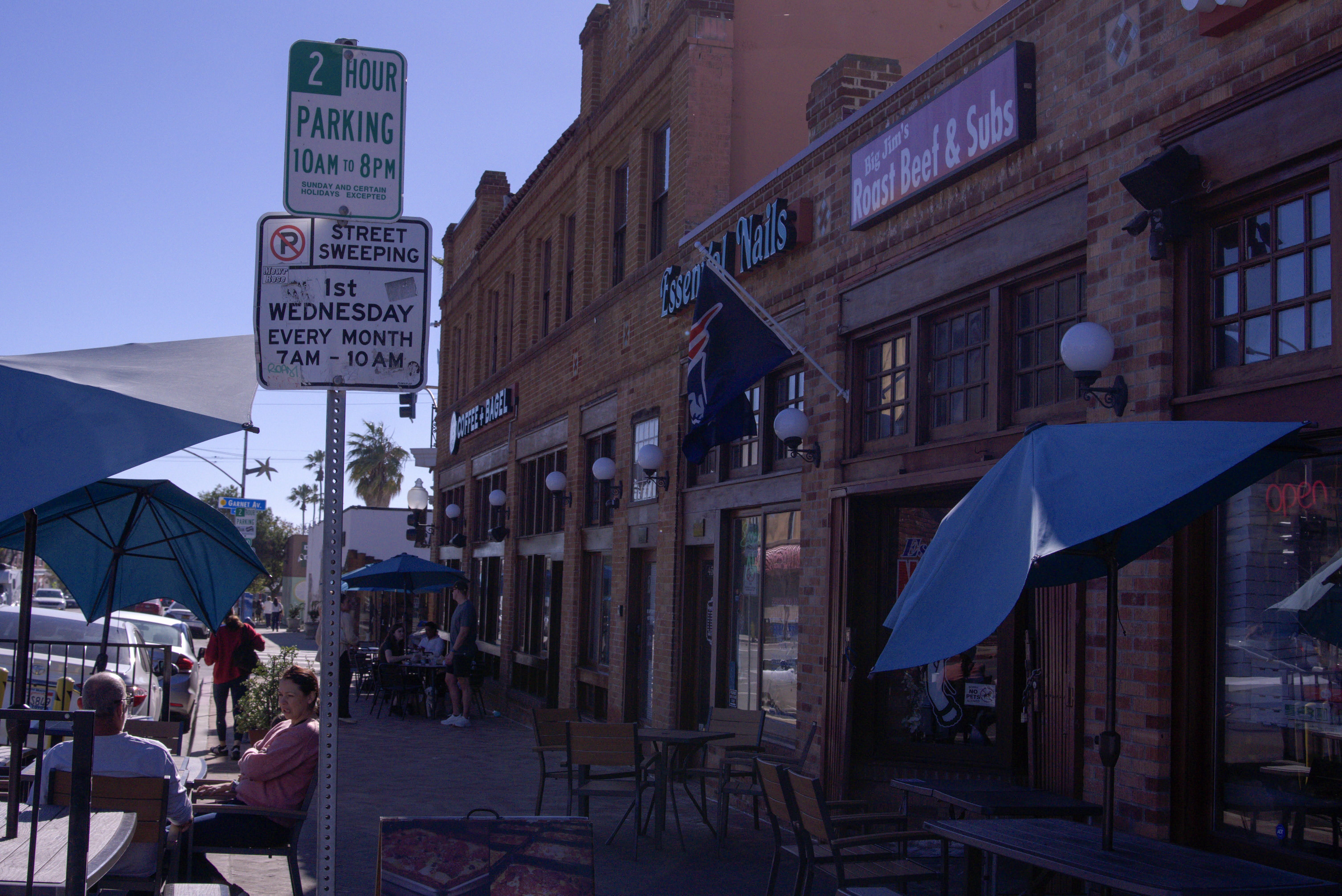 A bunch of locals eating outside of Big Jim's Roast Beef during lunch time rush located in Pacific Beach, San Diego