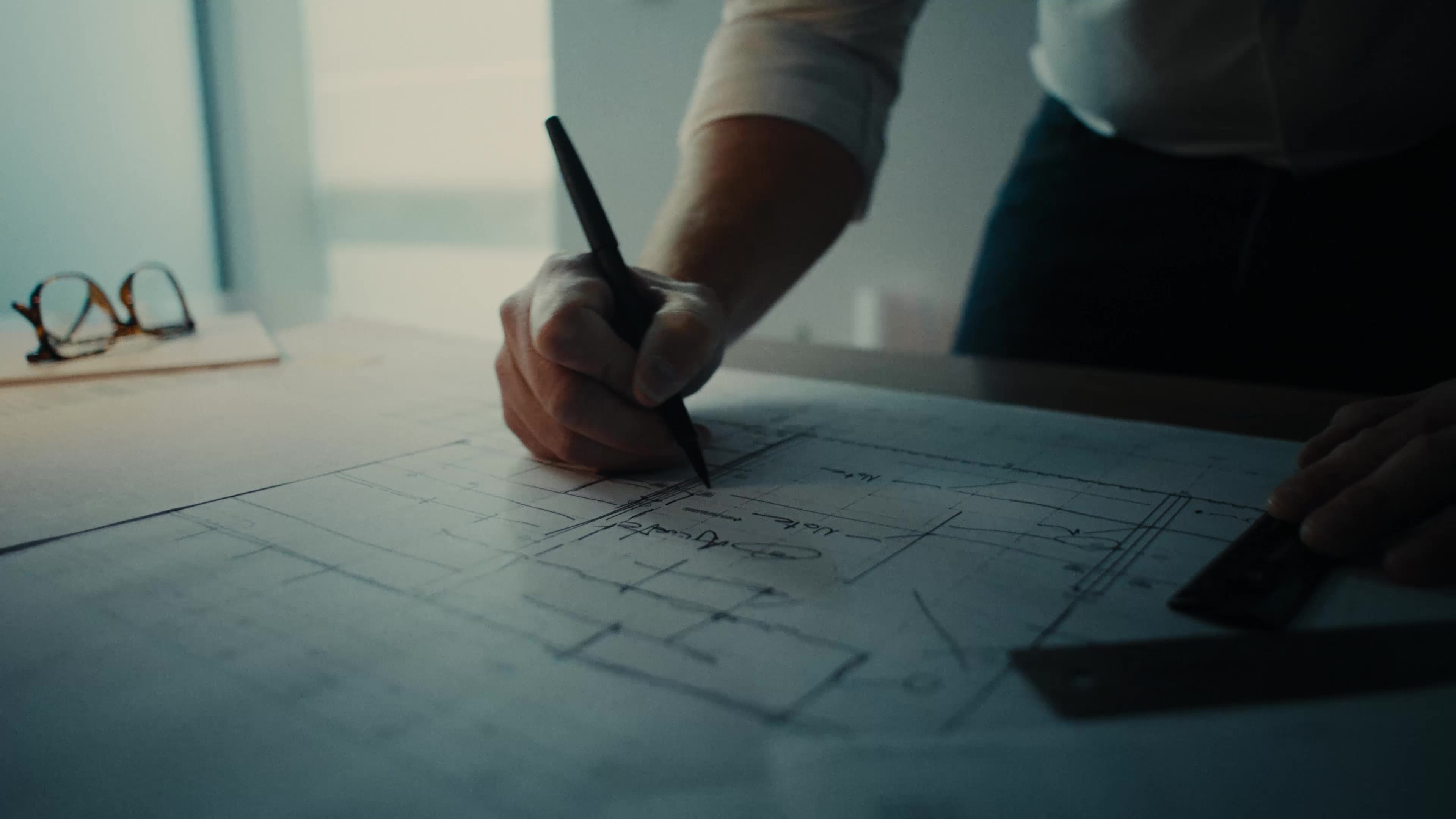 Hands working on a device or document, representing professional results delivered to clients.