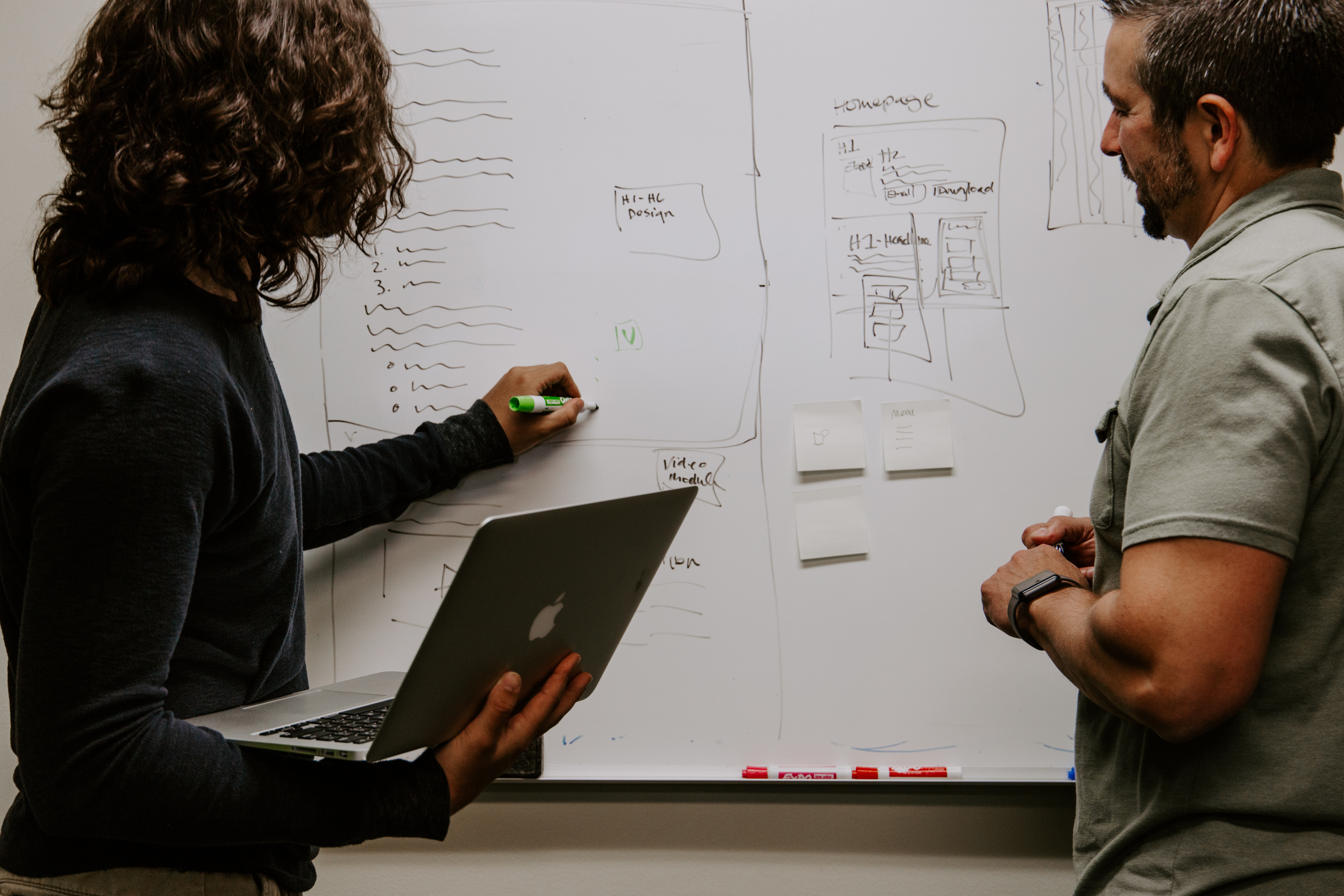 woman explaining to coworker about importance of voice of customer sentiment analysis