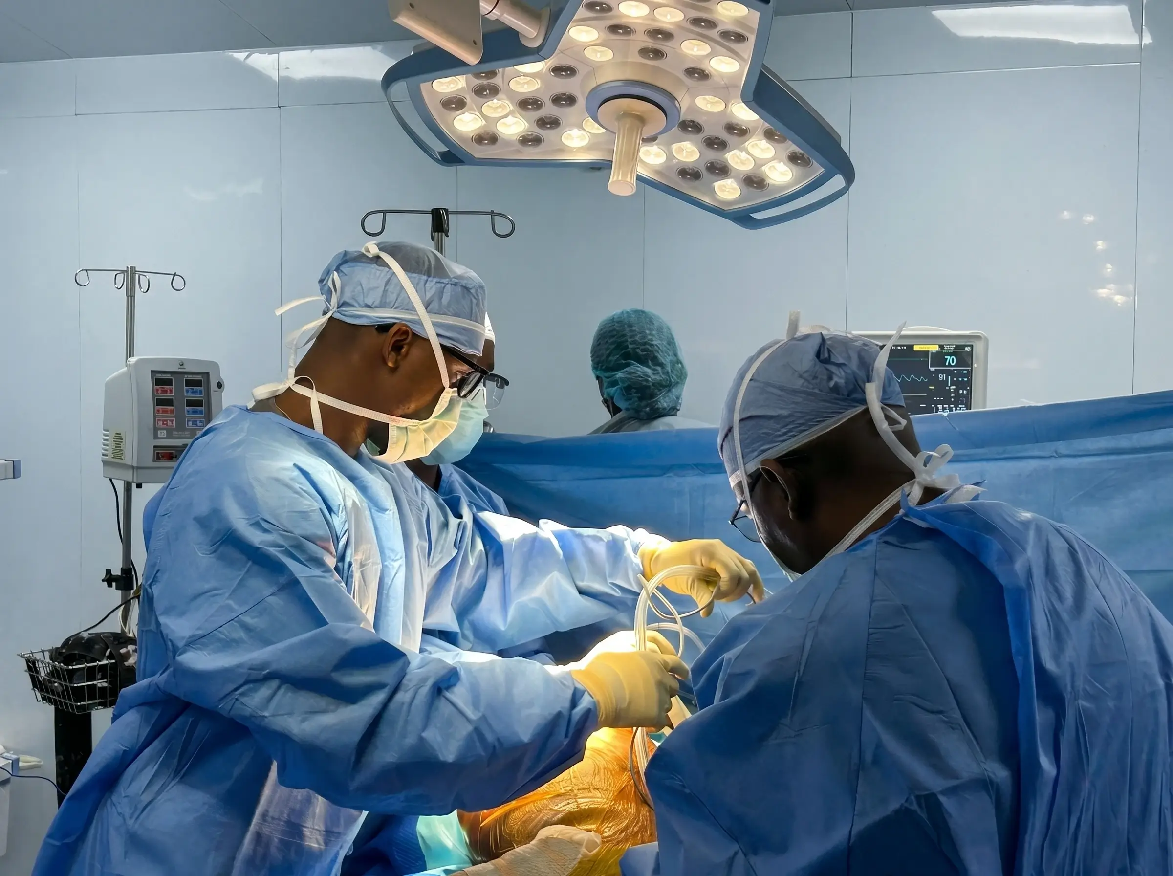 Dr. Julius Oni and Dr. Ishaq Ojodu performing joint replacement surgery at The O.N.I. Clinic operating theatre