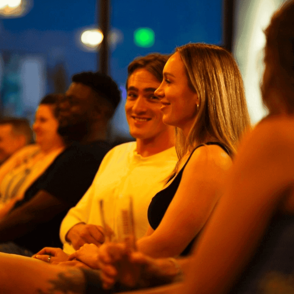 A couple enjoying an evening at a St Pete Standup comedy show