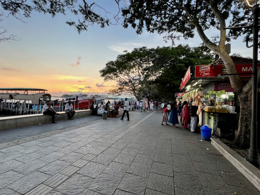 Marine drive of Kochi with vendors, boat jetties and crowds.