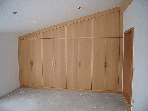 wooden closet built in an empty room upstairs