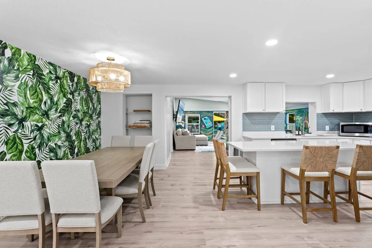 Dining area with leaf wallpaper with kitchen island at Private Backyard Resort, Bradenton, Florida
