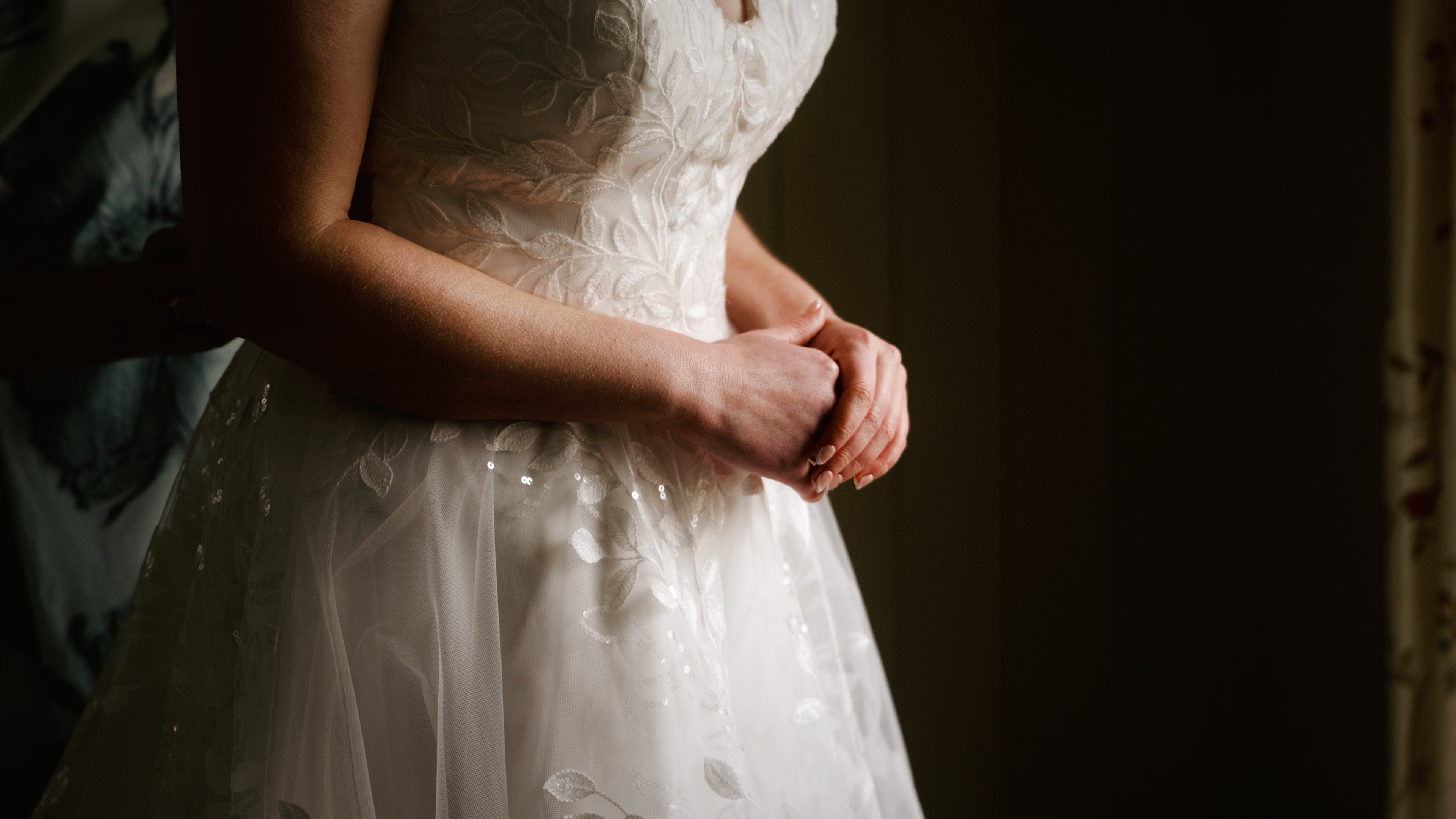 Close-up of bride’s wedding dress detail during bridal preparations at Manor Mews
