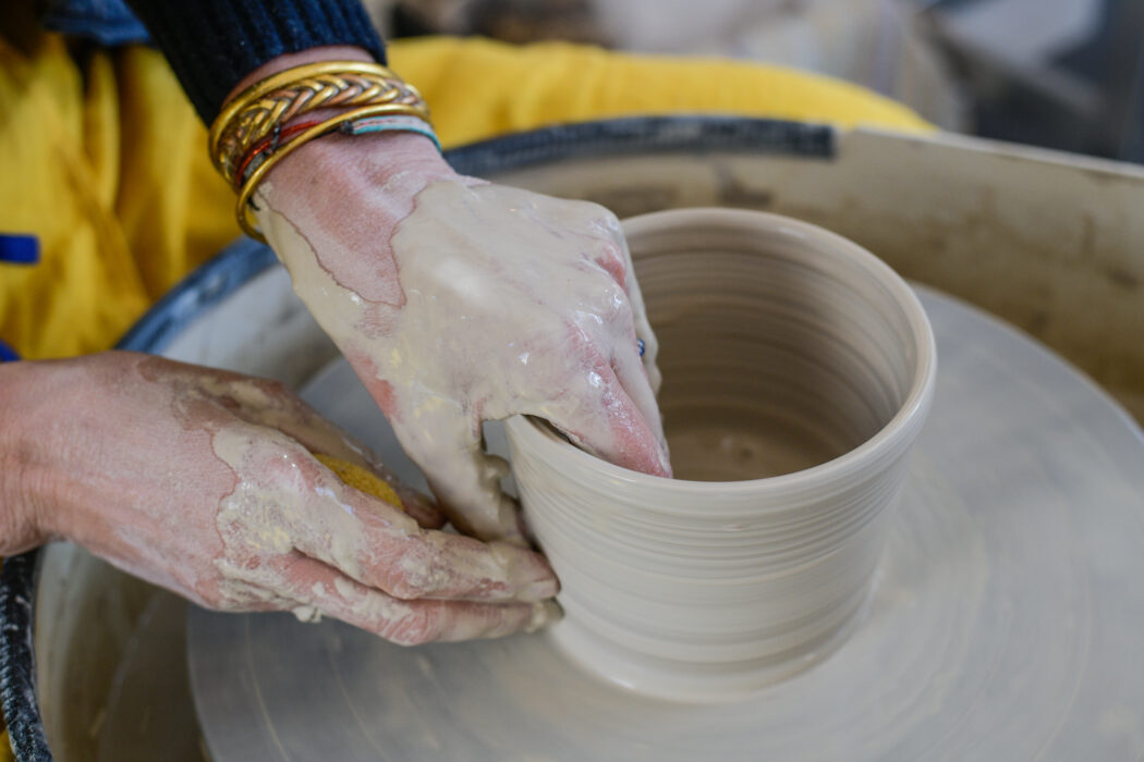 brown and white concrete house near green trees during daytime