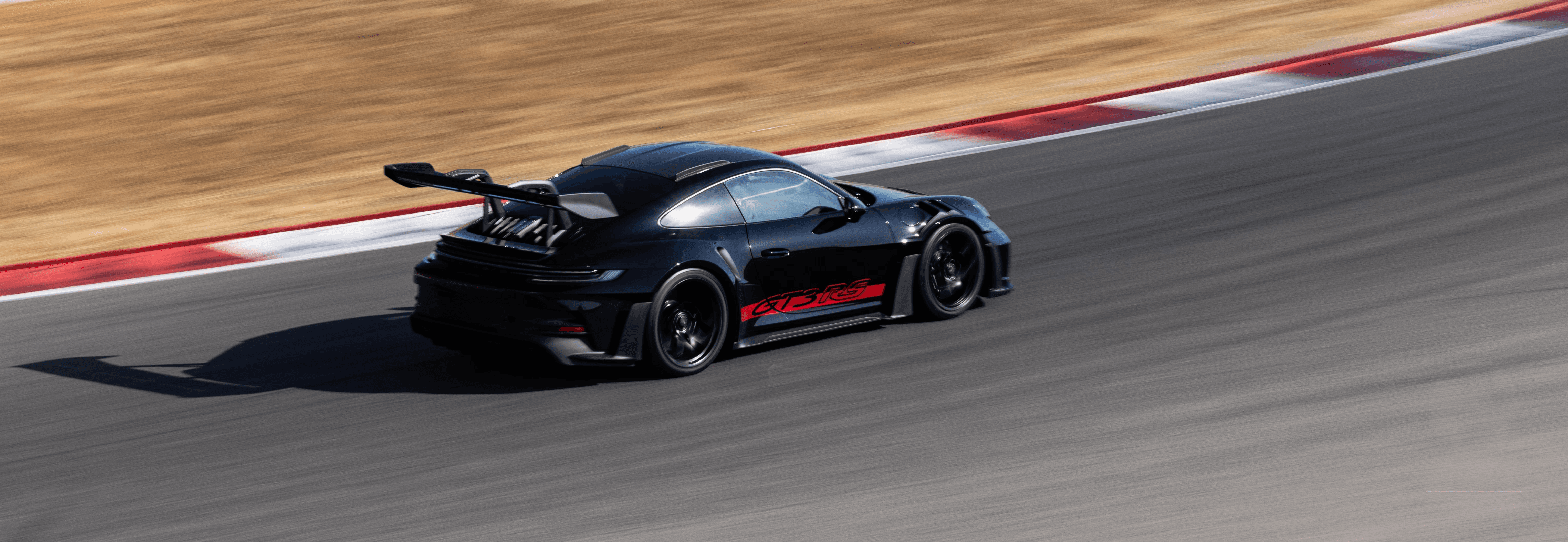 Porsche GT3 RS taking high-speed corner at Autódromo Internacional do Algarve Portimão