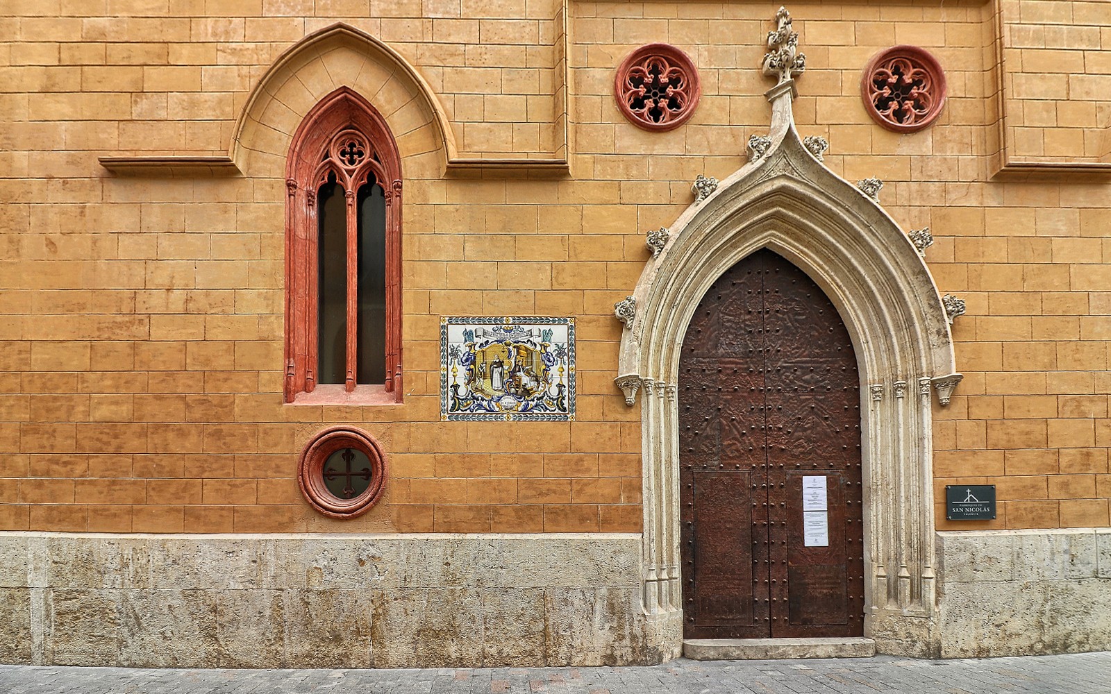San Nicolas Church ornate wooden door with Gothic arch in Valencia, Spain.