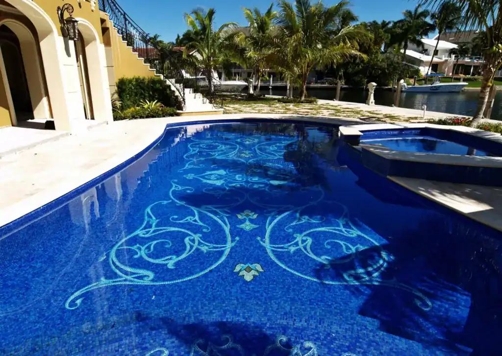 Mosaic glass pool with intricate floral patterns on Naples Bay, showcasing artistic mosaic craftsman.
