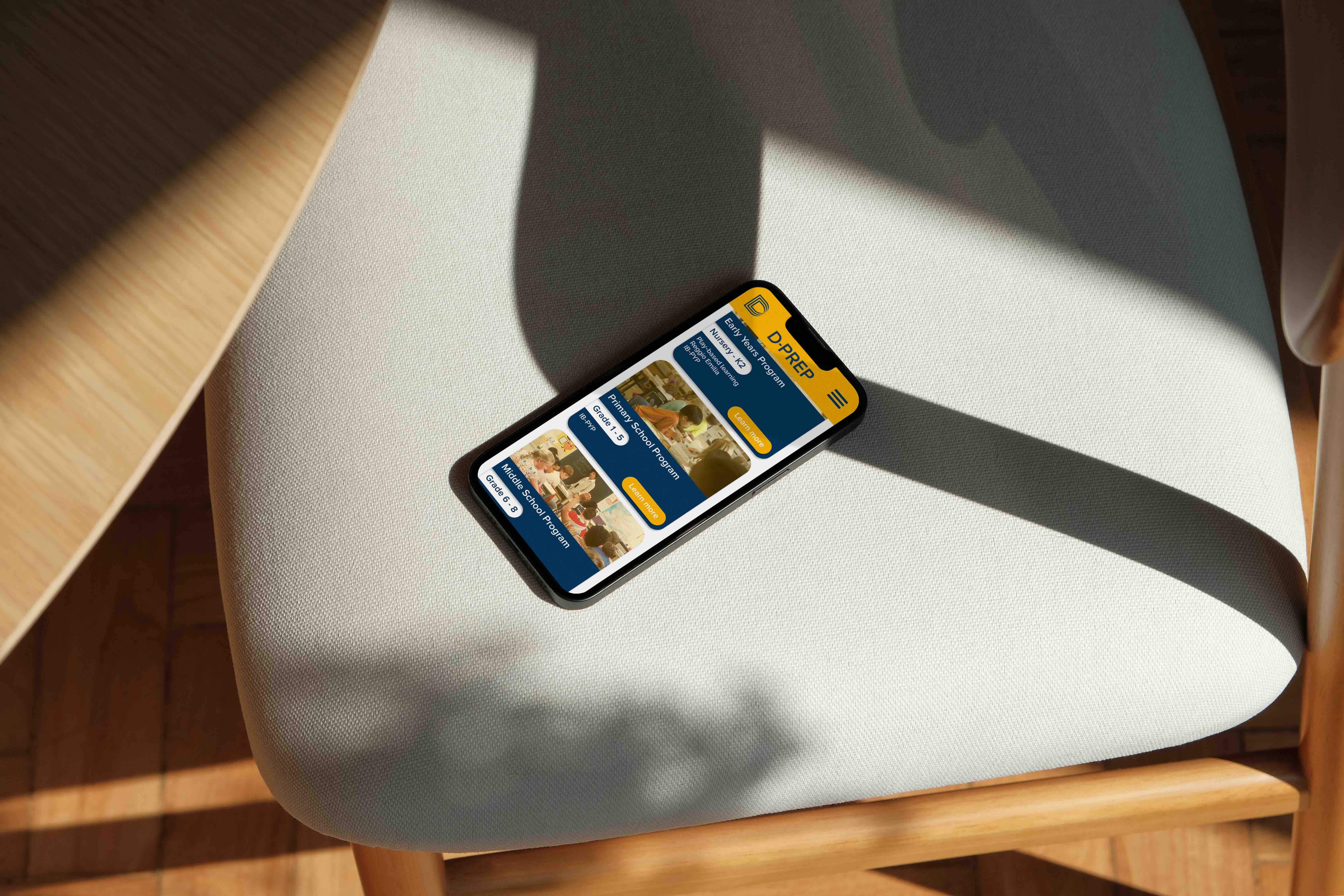 Branded homepage on a phone for an international school