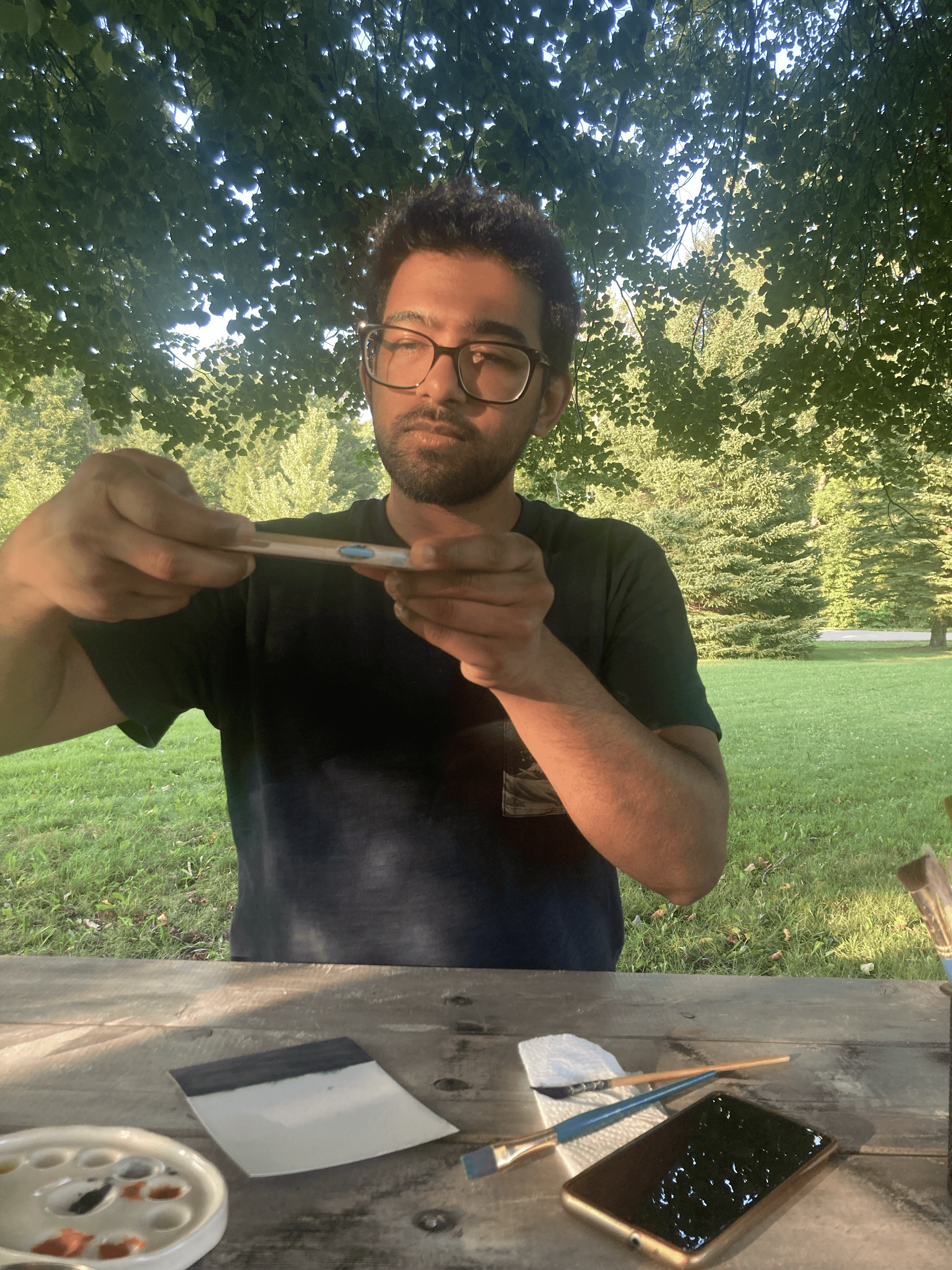 Laptop screen displays a cityscape next to lit candles.