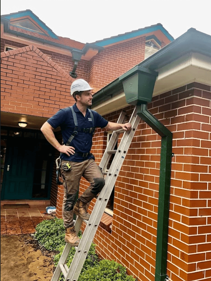 Two construction workers working on a roof