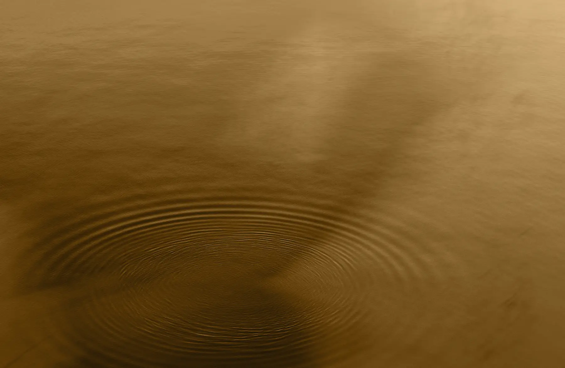 A serene body of water with gentle ripples creating a calm and meditative atmosphere, ideal for a peaceful wellness and spa experience.