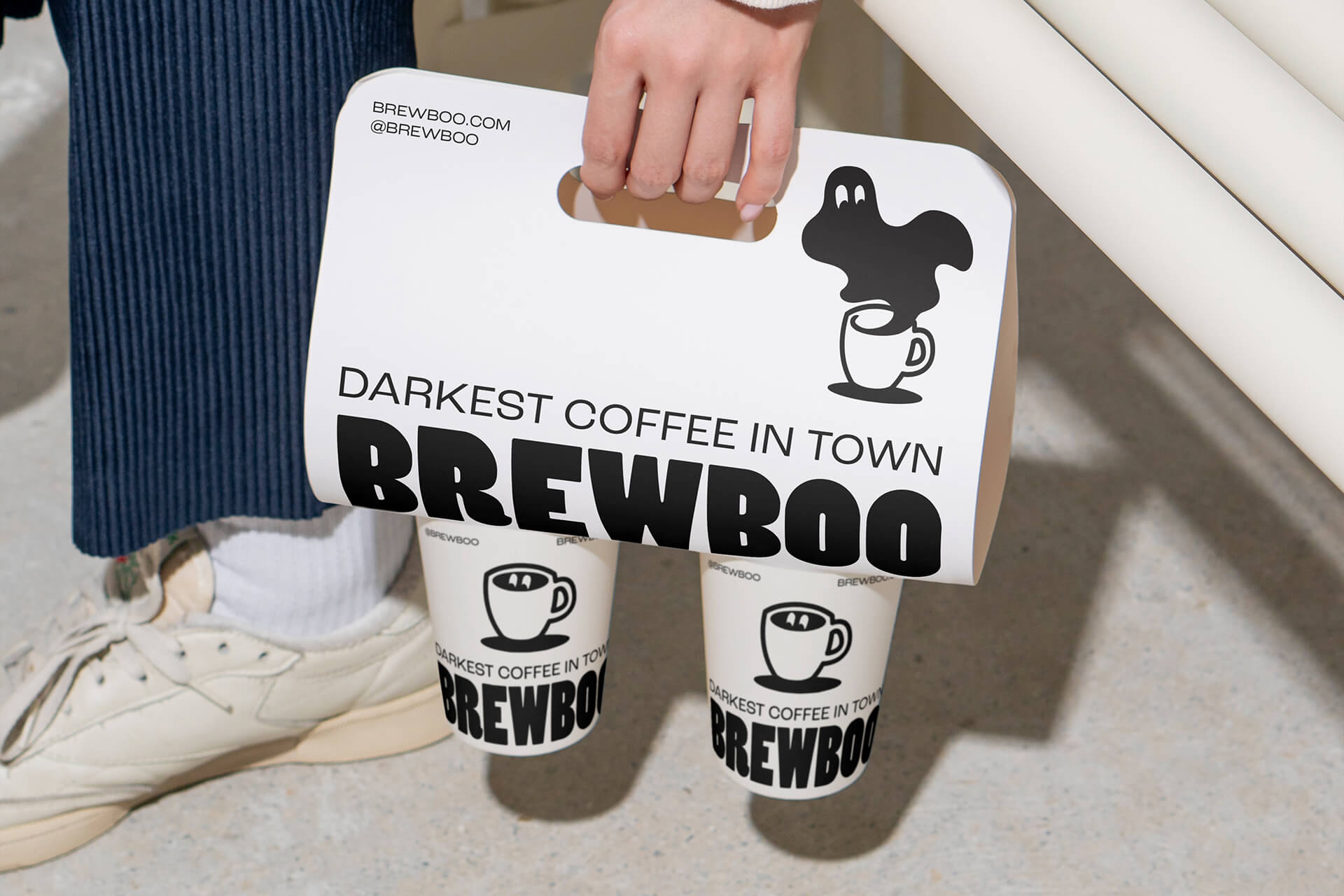 Two coffee mugs branded with the Brewboo logo and a ghost design