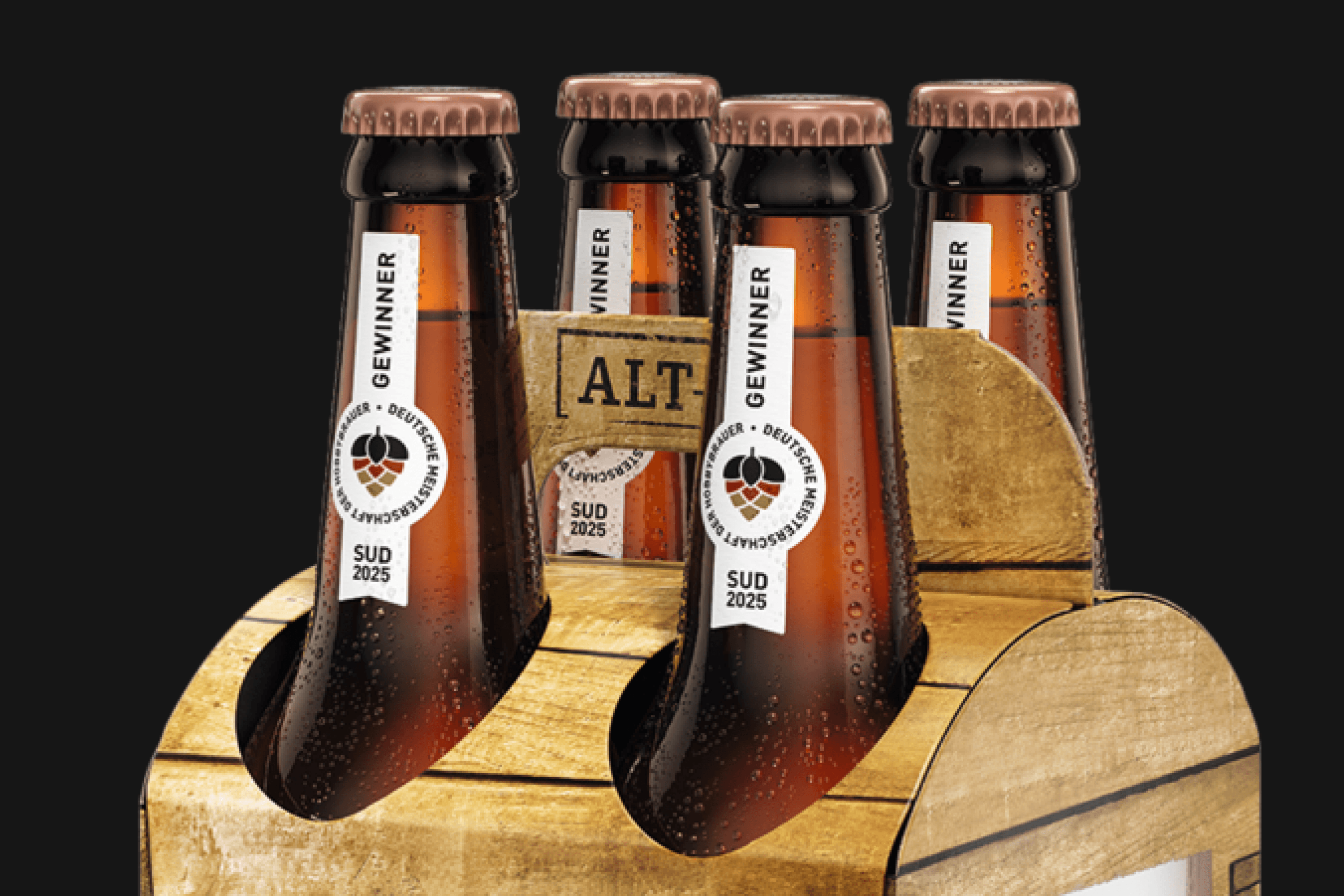 Four bottles of beer in a wooden carrier.